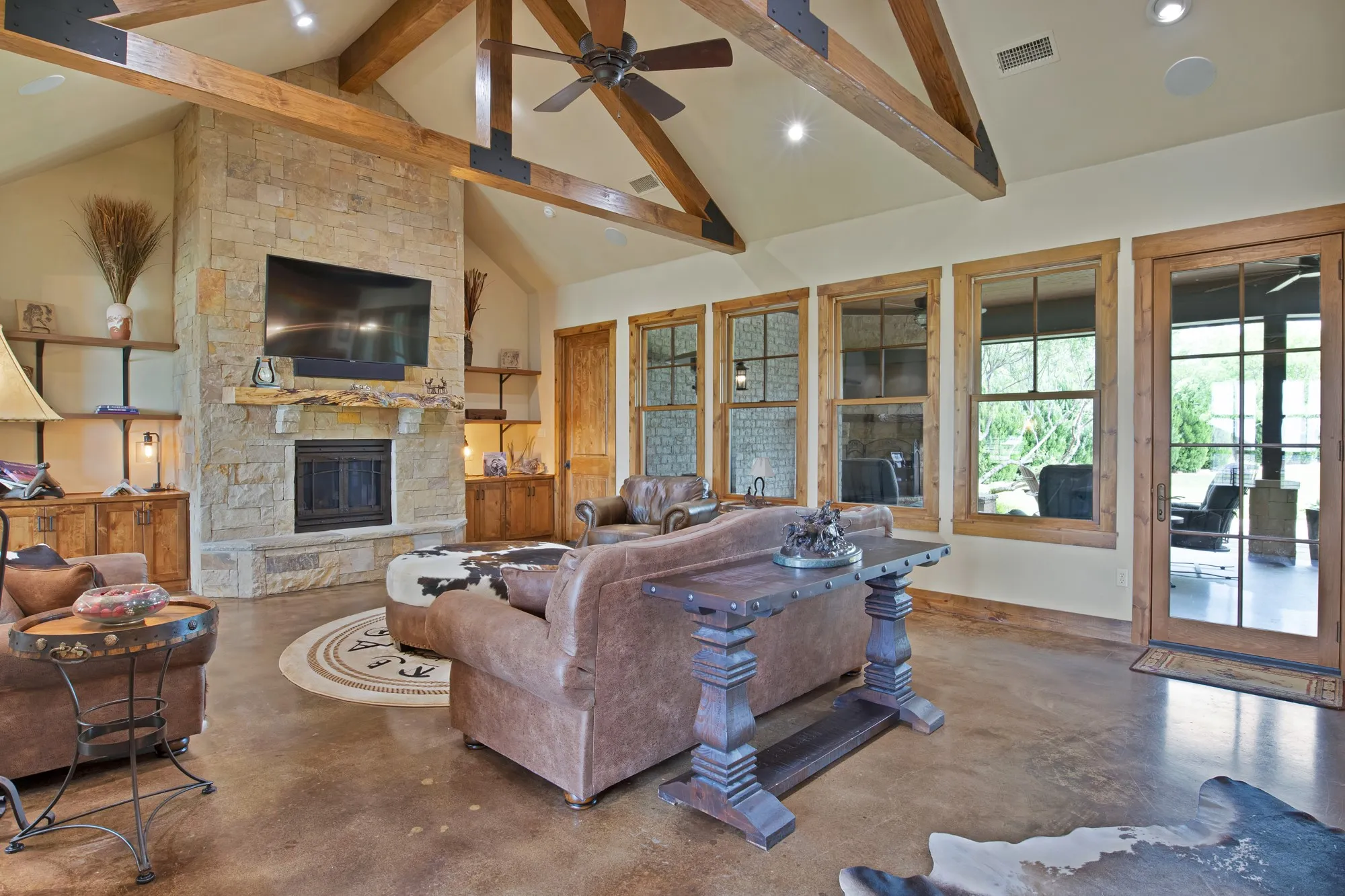Vaulted ceiling with exposed wood beams and ceiling fan