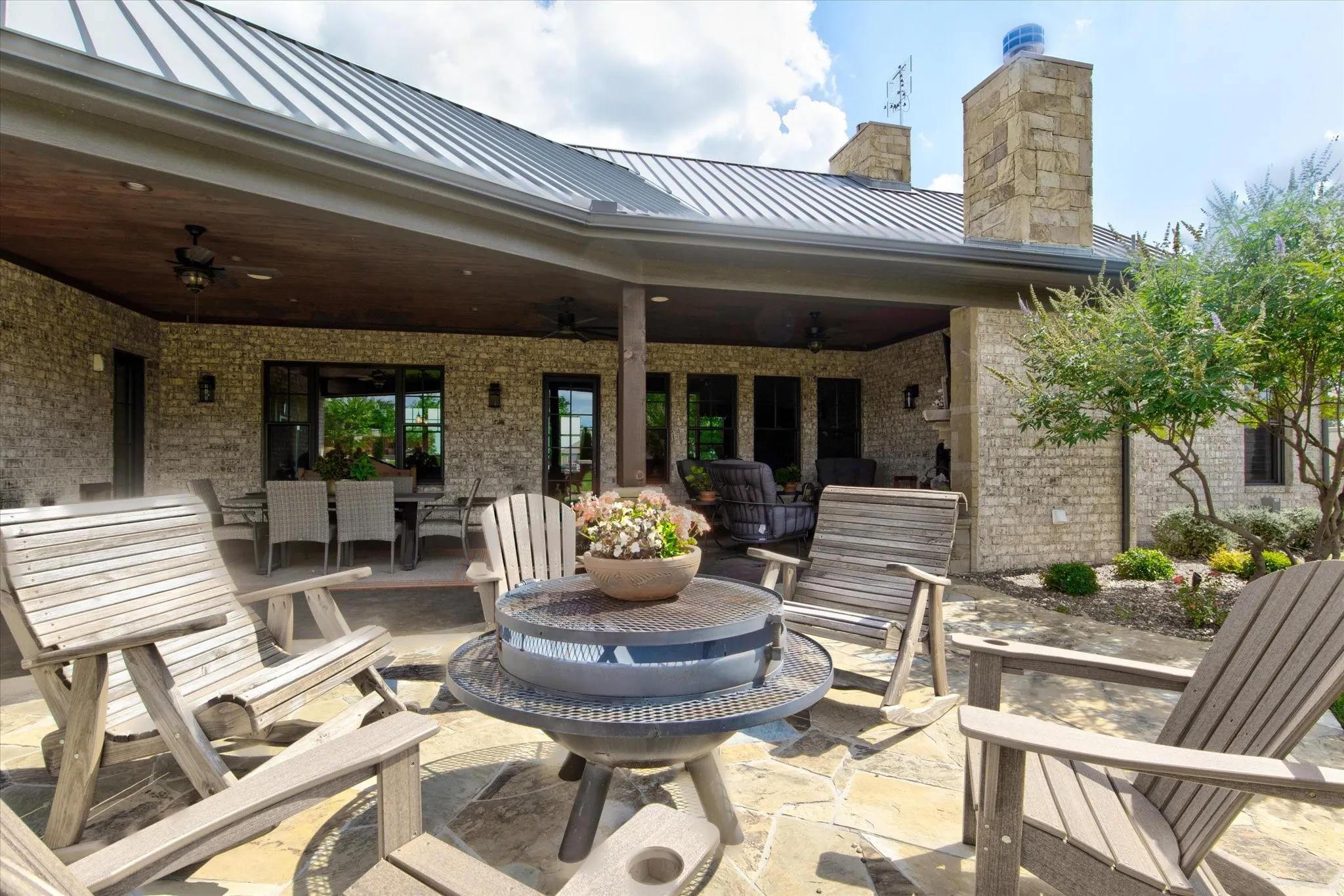 Expansive flagstone patio area with a covered outdoor living space