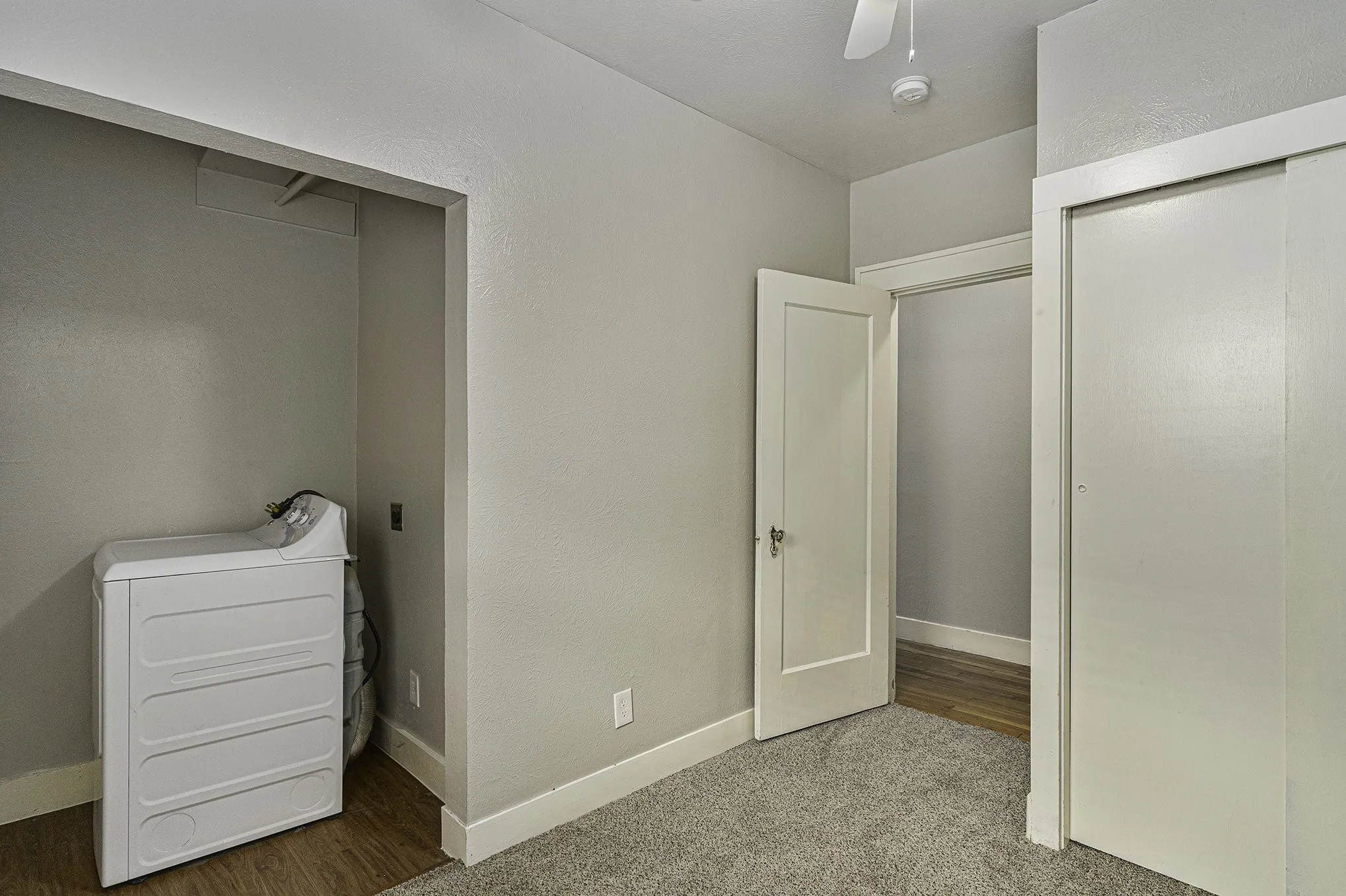 Unfurnished bedroom with a closet, carpet, and ceiling fan