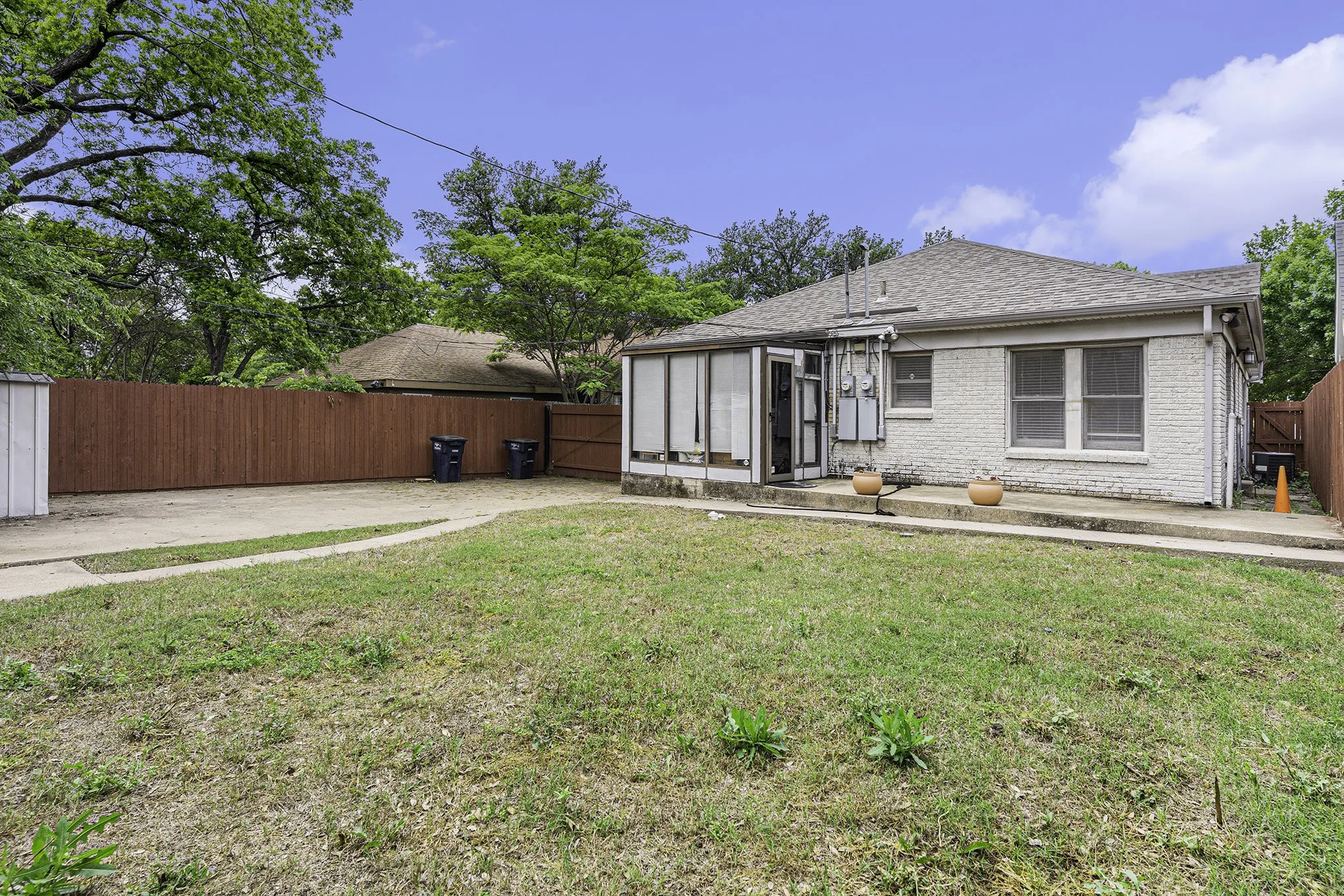 Back of house with a lawn