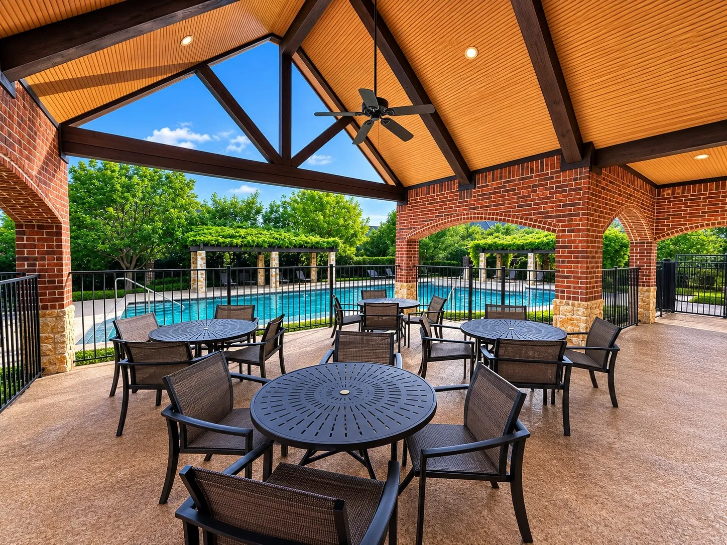 Covered outdoor patio area featuring brick arches and stone accents