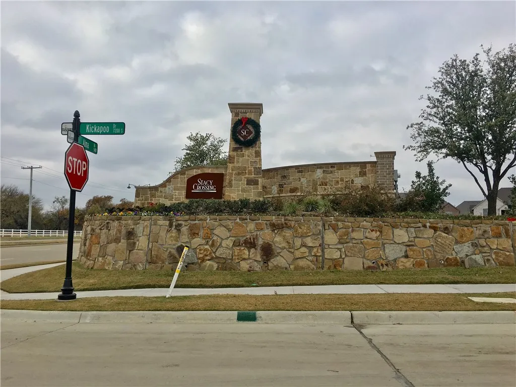 Community entrance sign for the McKinney Texas townhome neighborhood surrounding 7424 Mitchell Drive, showcasing an established residential subdivision with attractive stone monument sign, tree lined streets, and convenient North Texas location near McKinney shopping, restaurants, schools, medical facilities, and DFW commuter access.