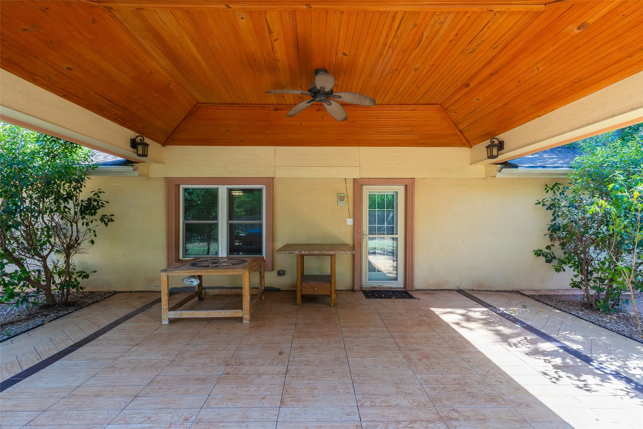 Covered outdoor patio featuring a wood-finish tongue and groove ceiling, recessed lighting, and a ceiling fan