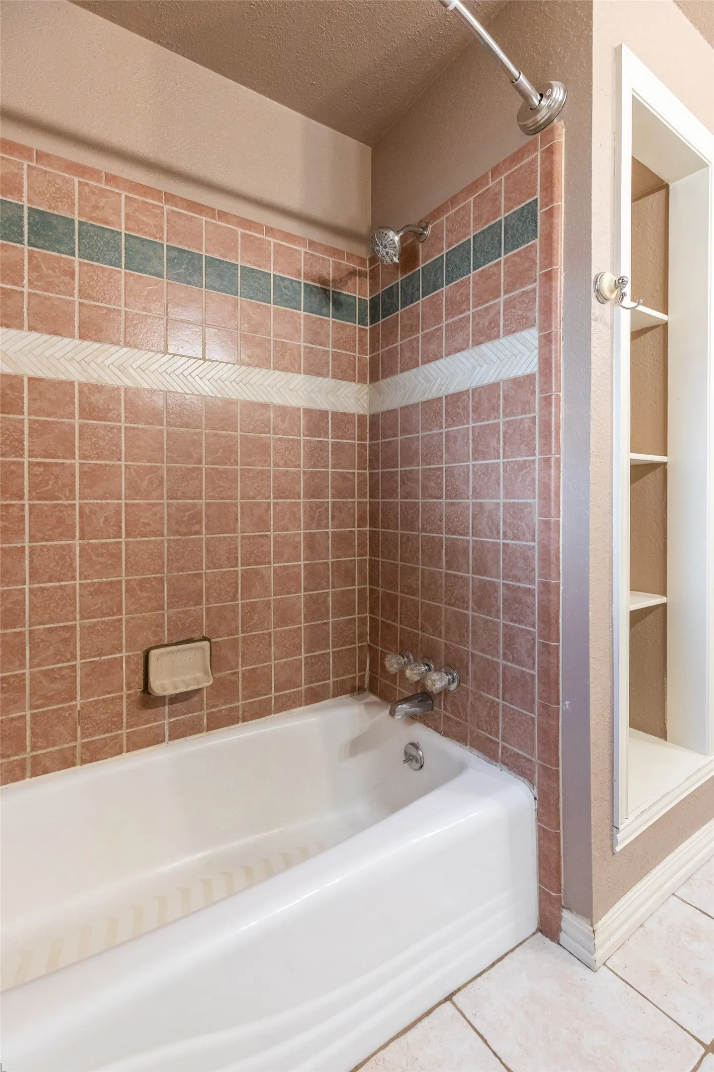 Full bathtub with a chrome faucet and shower head