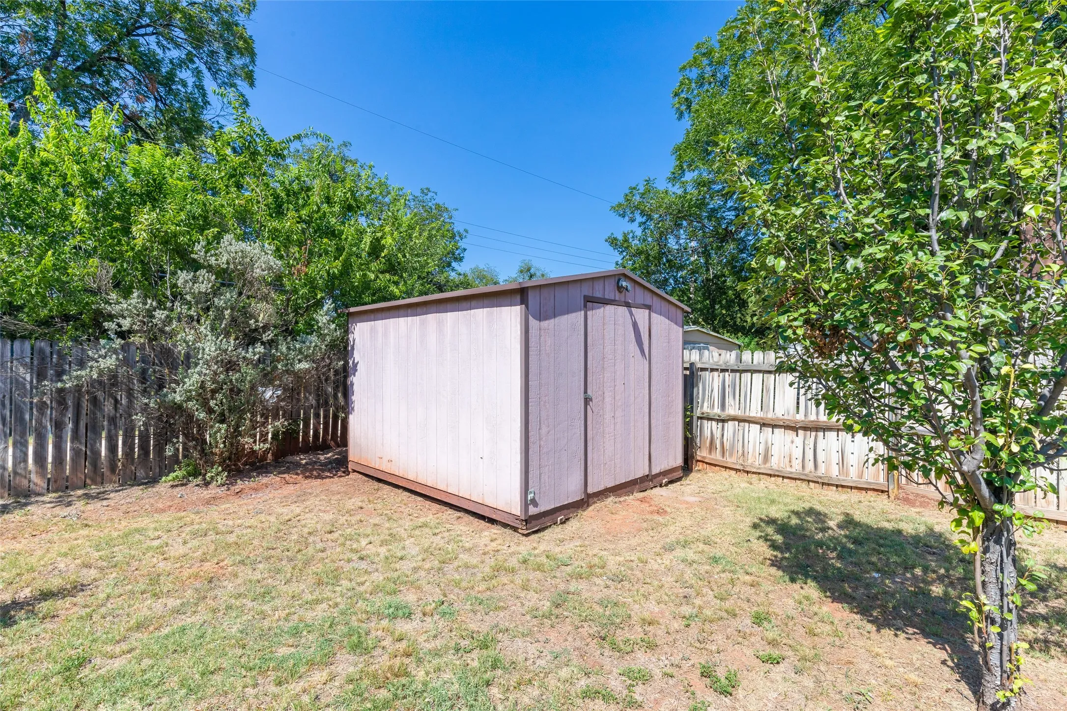 Outdoor storage shed with a panel siding exterior and a single entry door