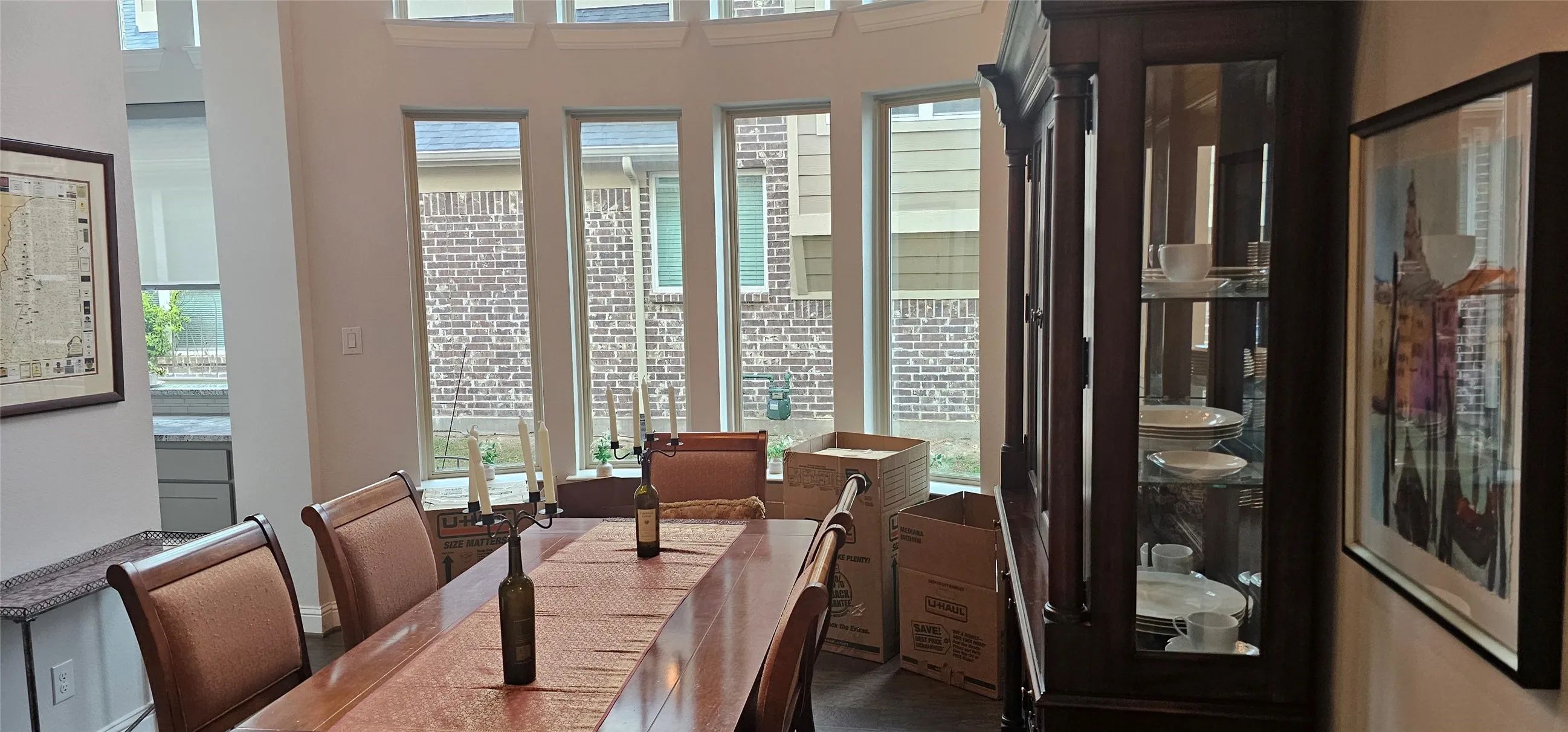 Bay window with multiple vertical windows, light-colored walls, recessed lighting, and wood-finish flooring