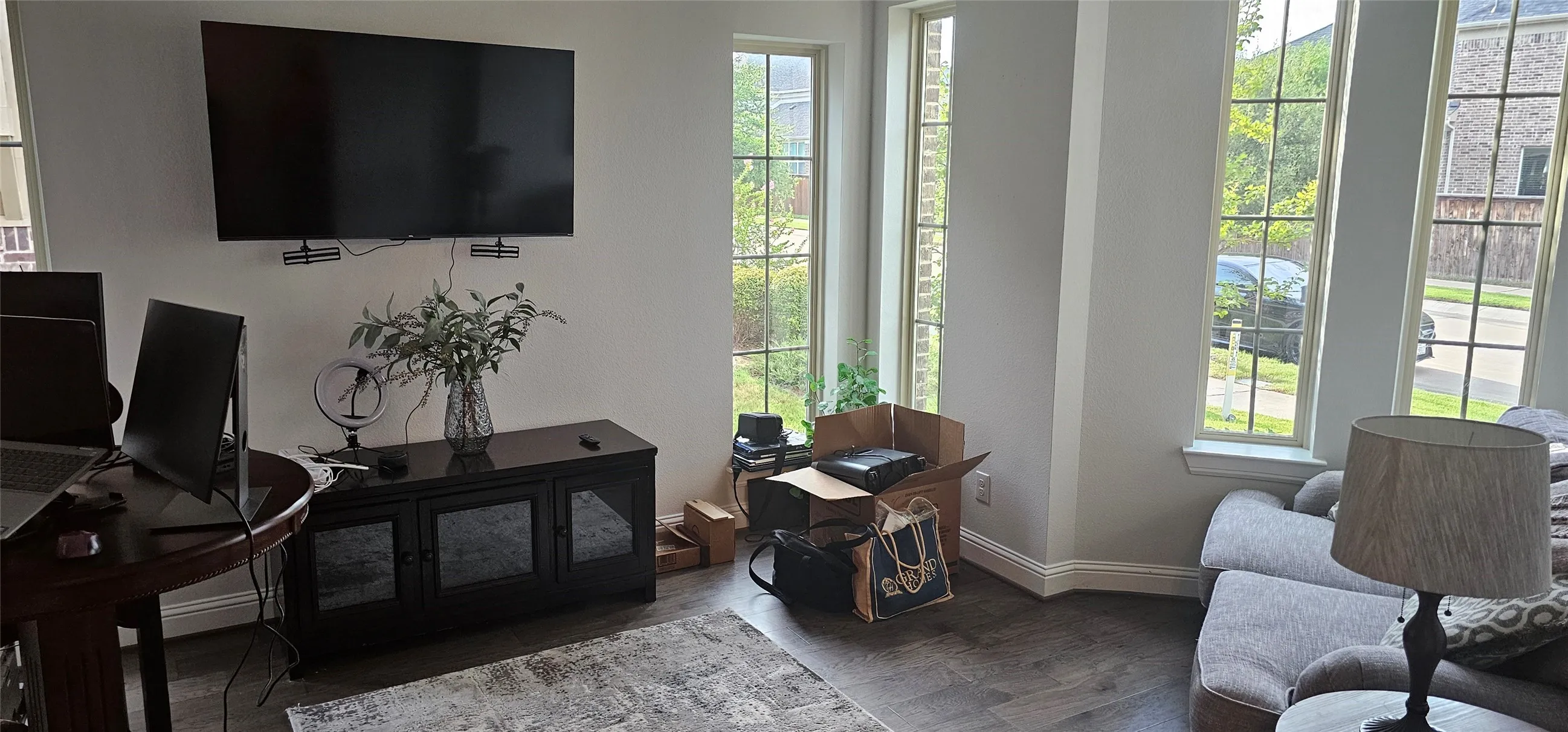 Hardwood-style flooring throughout, complemented by tall, mullioned windows