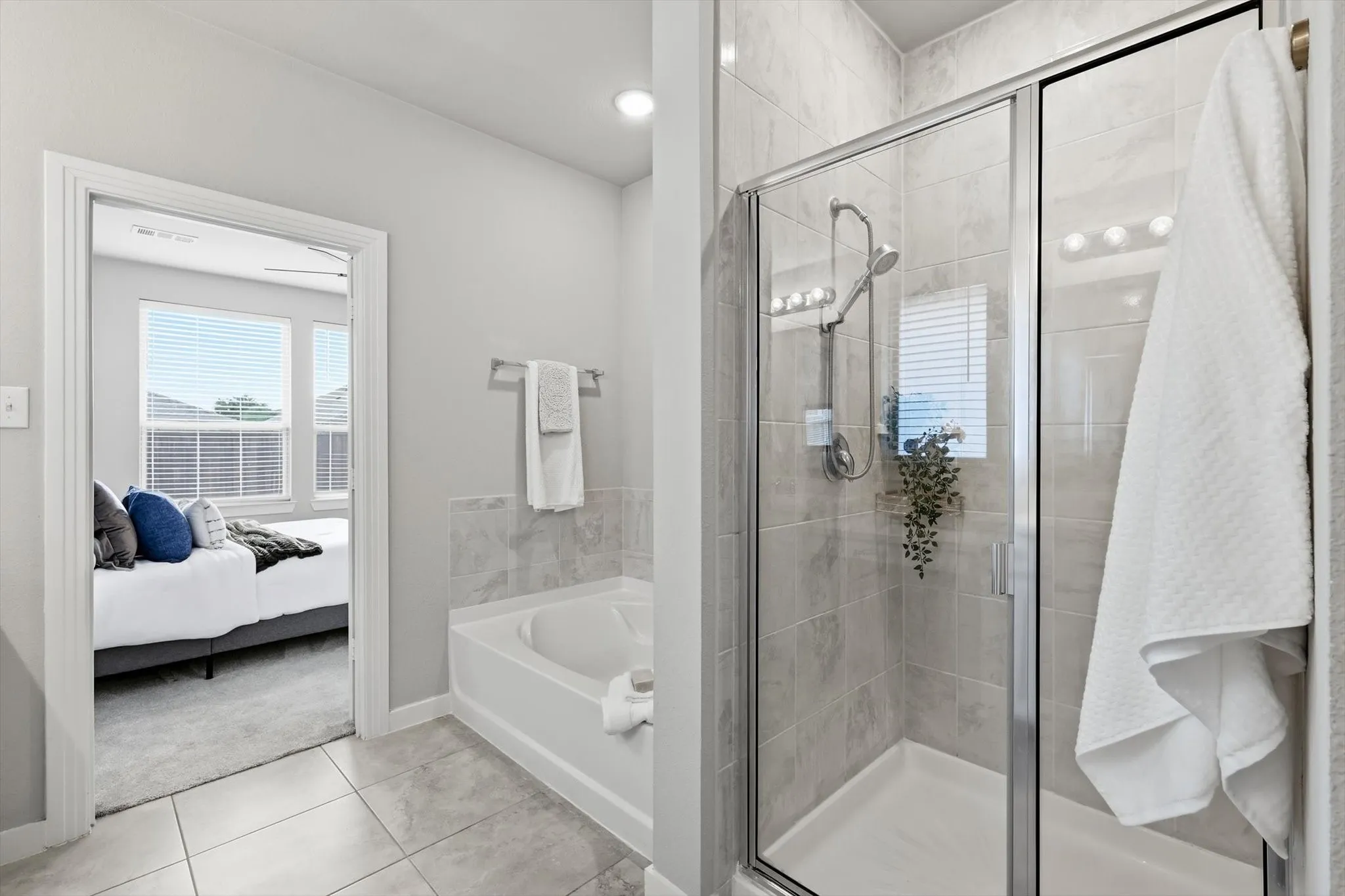 Large ensuite primary bathroom with dual vanities, make up or sitting space, separate shower and soaking tub with massive walk in closet.