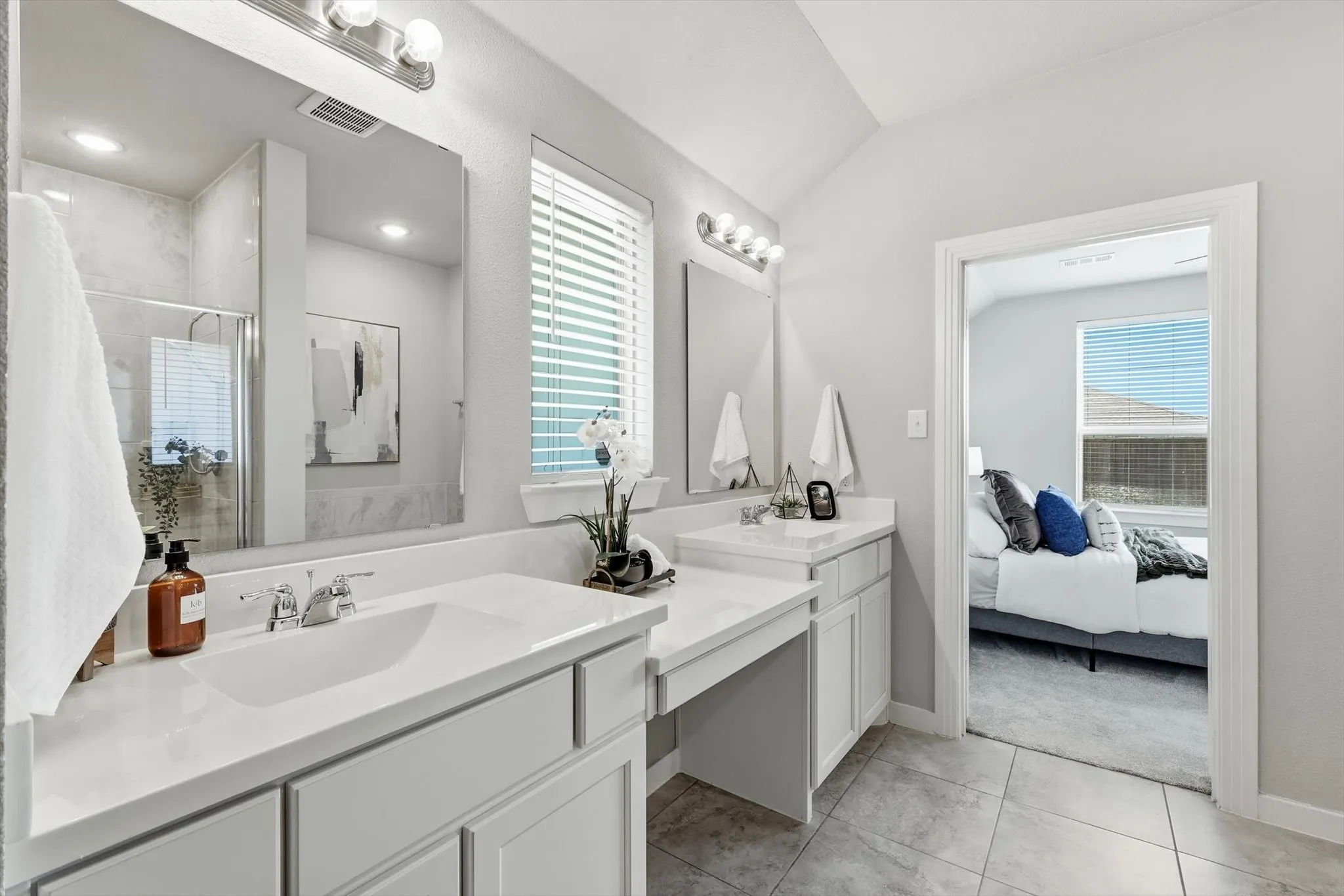 Large ensuite primary bathroom with dual vanities, make up or sitting space, separate shower and soaking tub with massive walk in closet.
