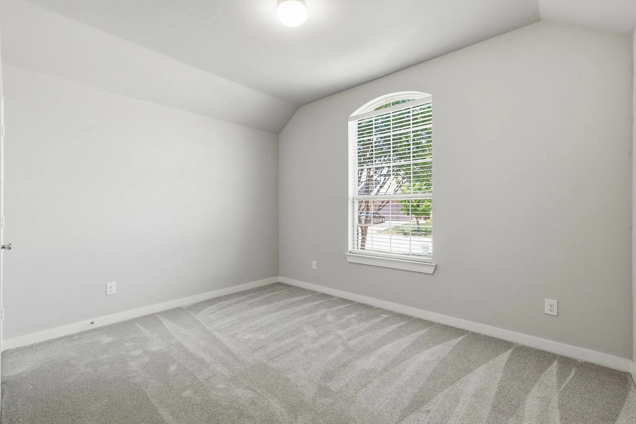 Bright secondary bedroom with walk in closet, recessed ceiling lighting and split bathroom.