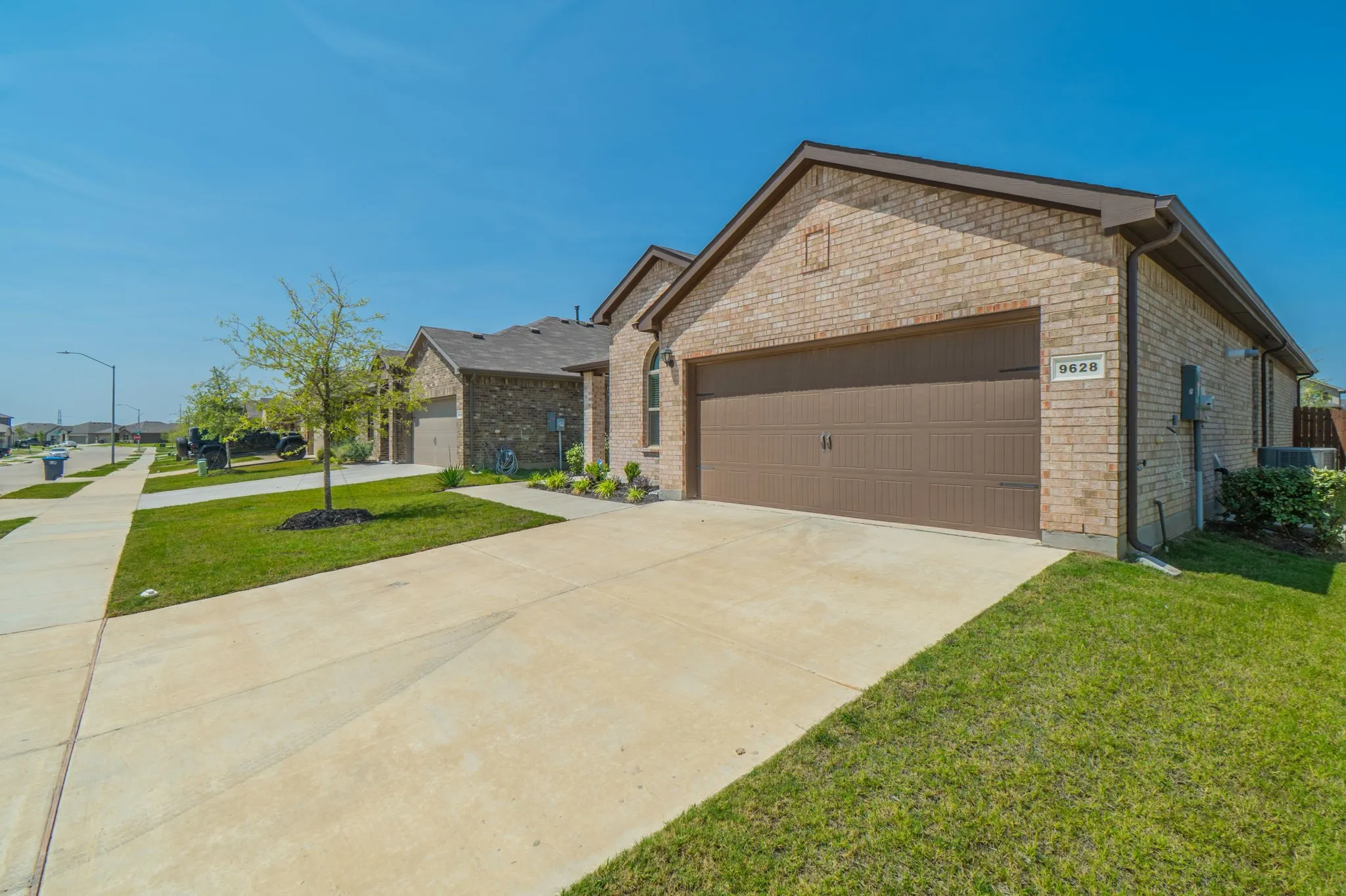 Brick exterior with a prominent front-facing garage