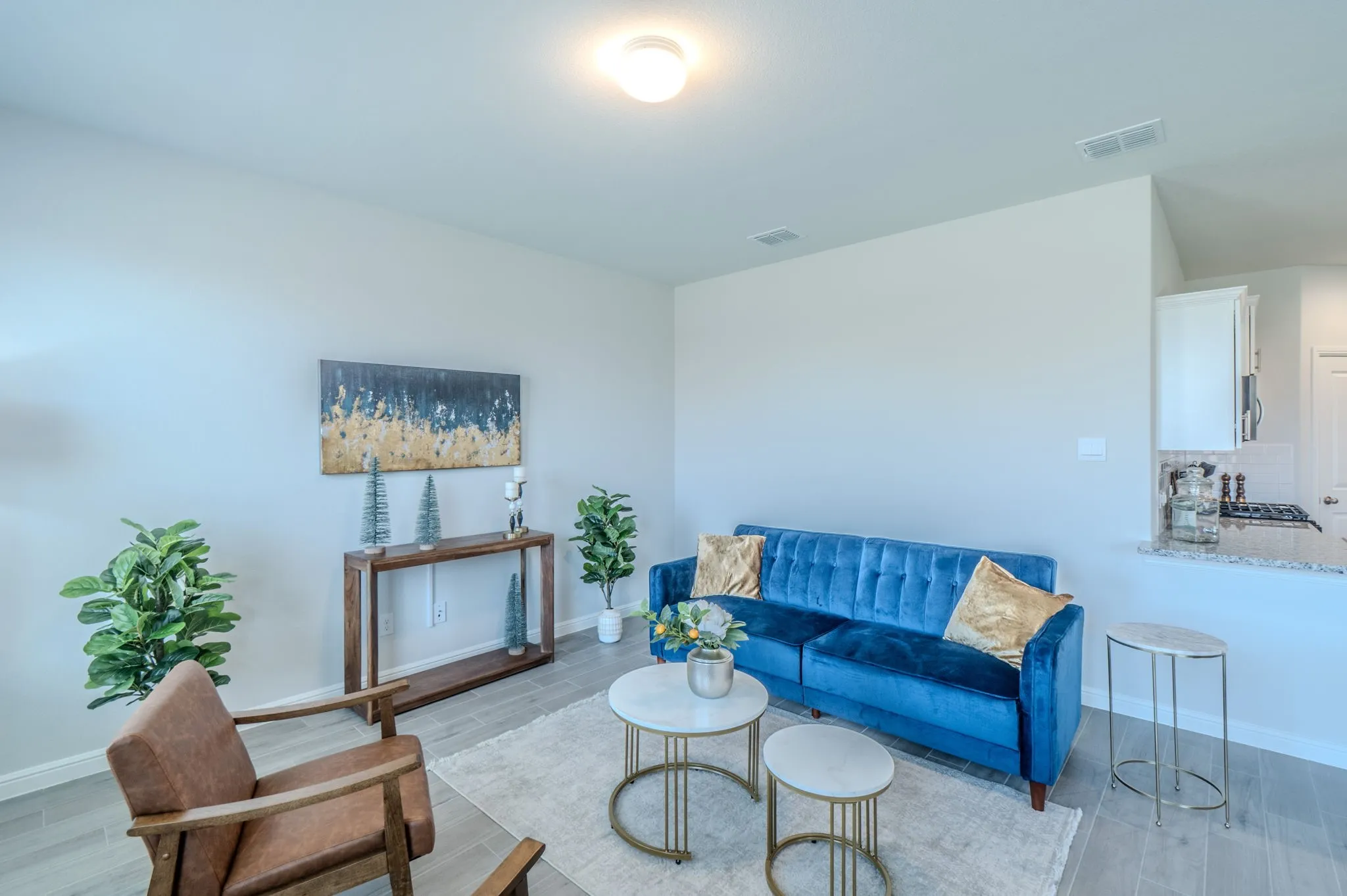 Open-concept living space featuring light wood-finish flooring, recessed lighting, and a neutral wall color