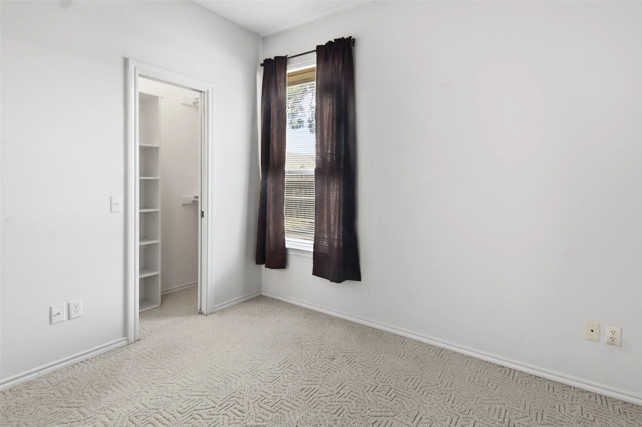primary bedroom with walk in closet