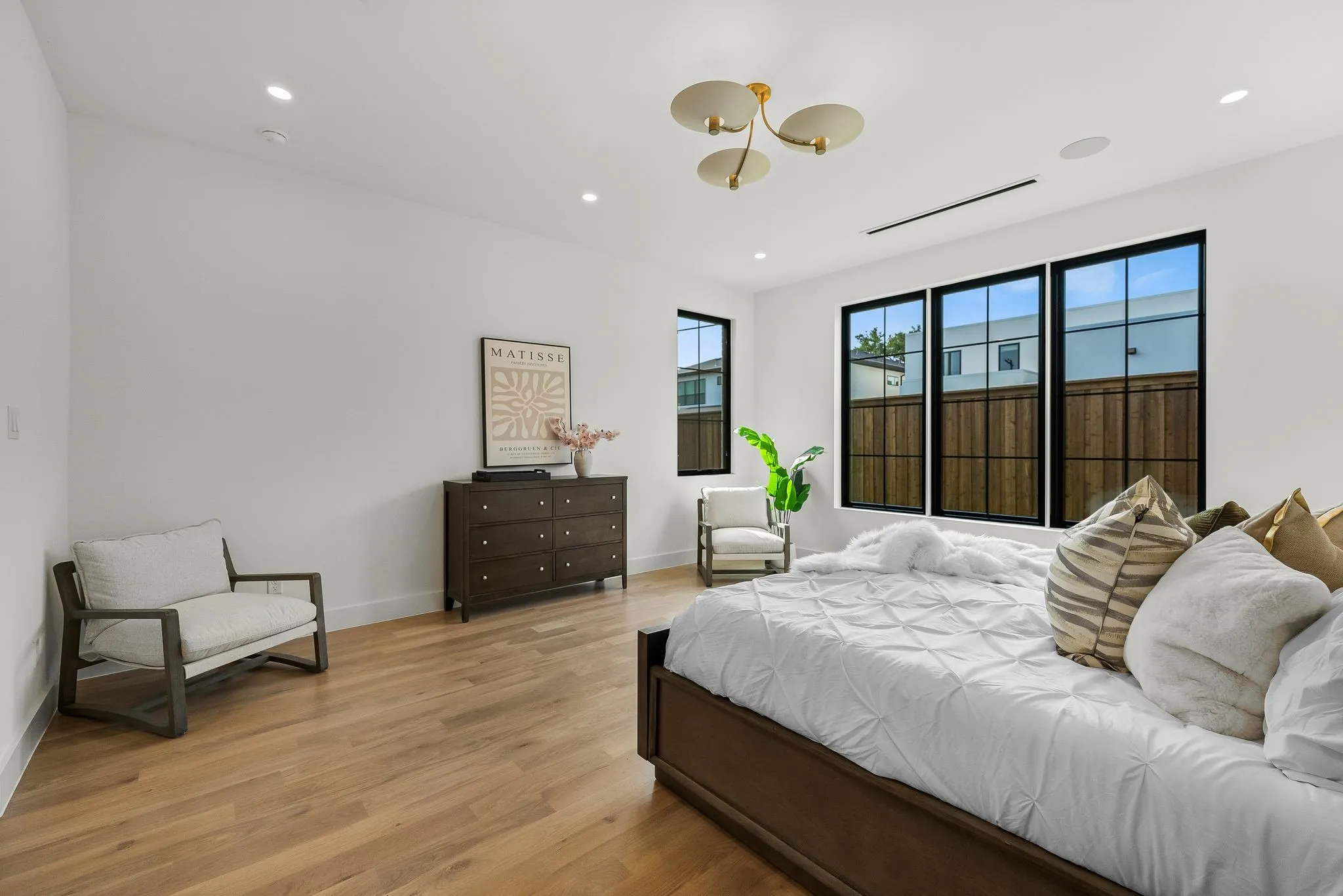 Hardwood-finish flooring complements white walls and recessed lighting