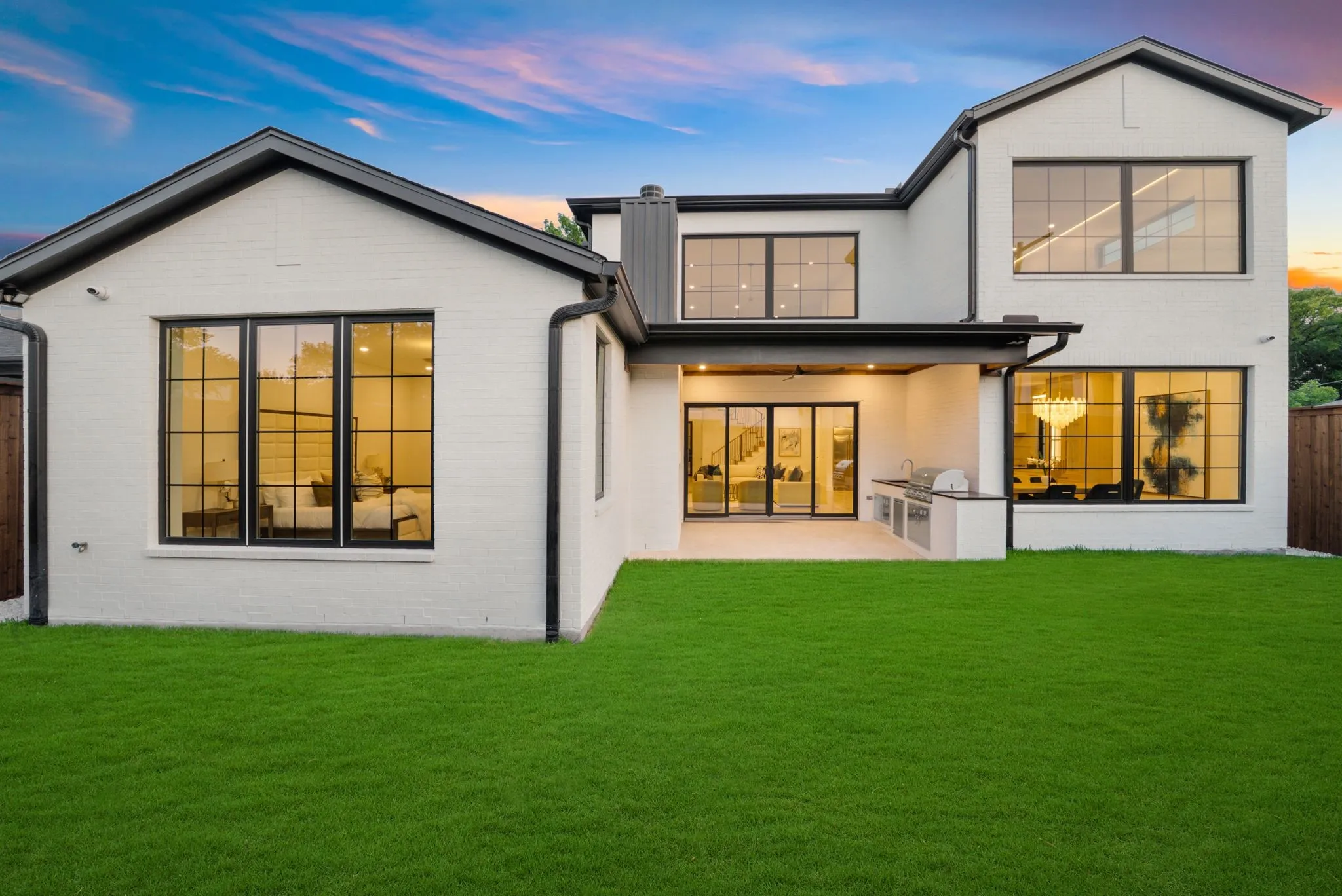 Modern white brick exterior with black trim and large grid windows