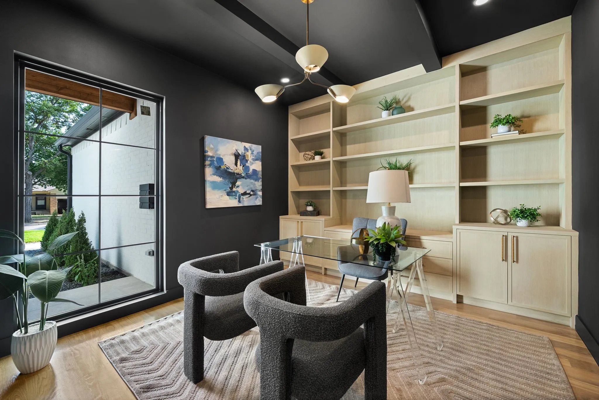 Dedicated room featuring extensive built-in shelving, integrated cabinetry, and wood-finish flooring