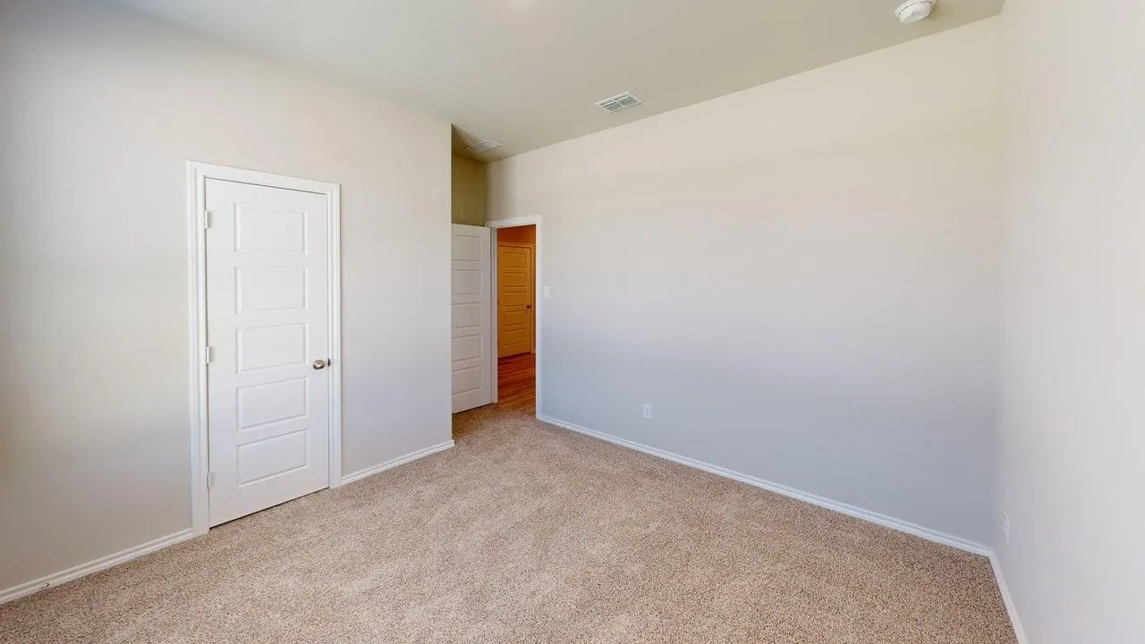 Spacious bedroom featuring neutral wall finishes, neutral carpet flooring, and abundant natural lighting