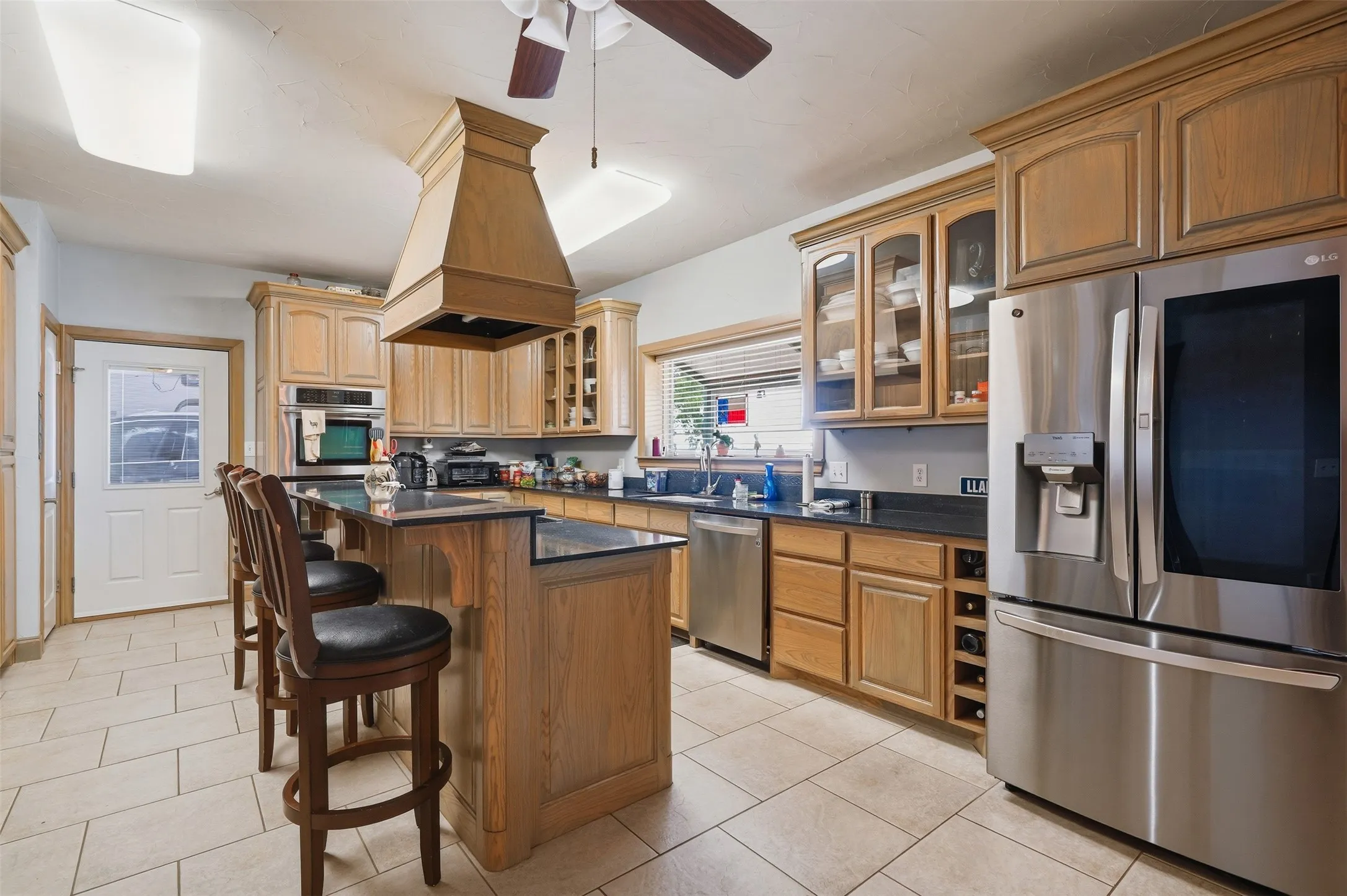 Open kitchen with dual ovens, large eat in island and beautiful cabinets with so much storage space