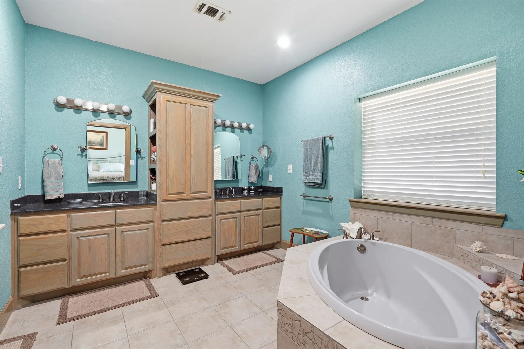 Primary bedroom with dual sinks and large garden tub