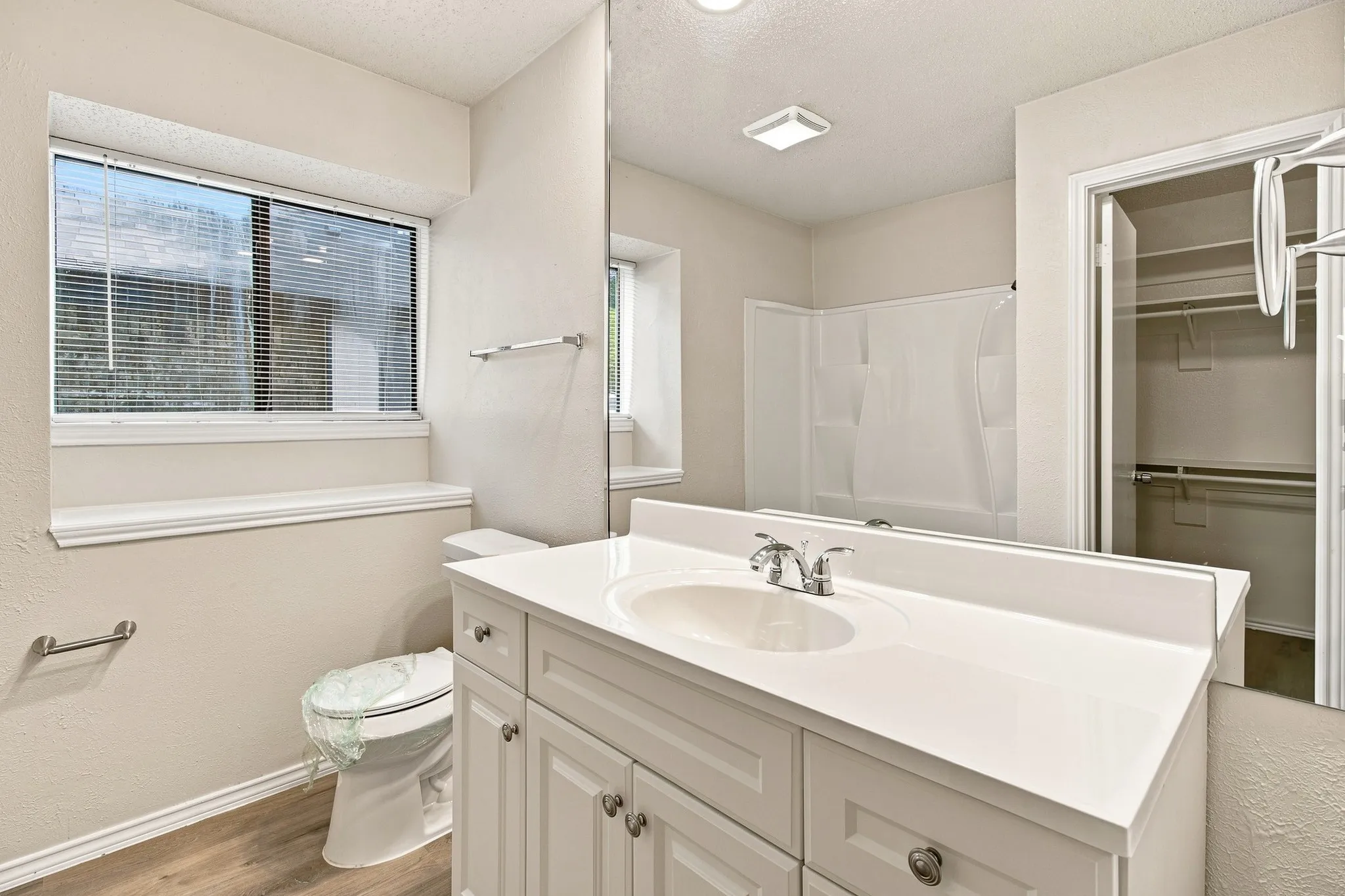 Bathroom featuring an updated vanity with a white countertop, chrome faucet, and integrated sink