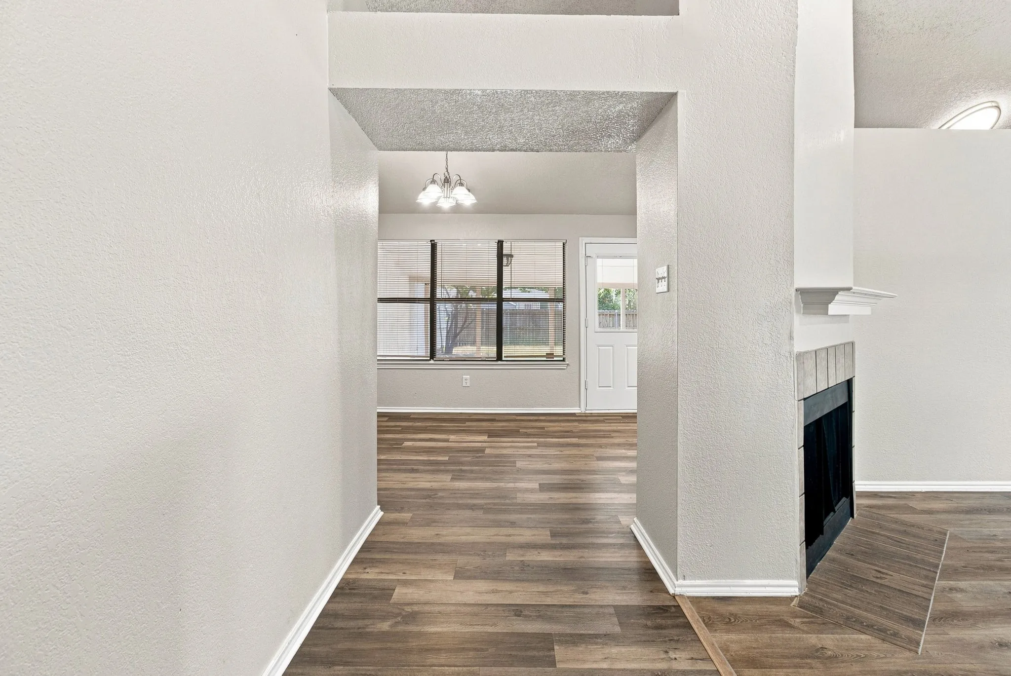 Interior entryway featuring wood-finish flooring, white baseboards, and a neutral wall color