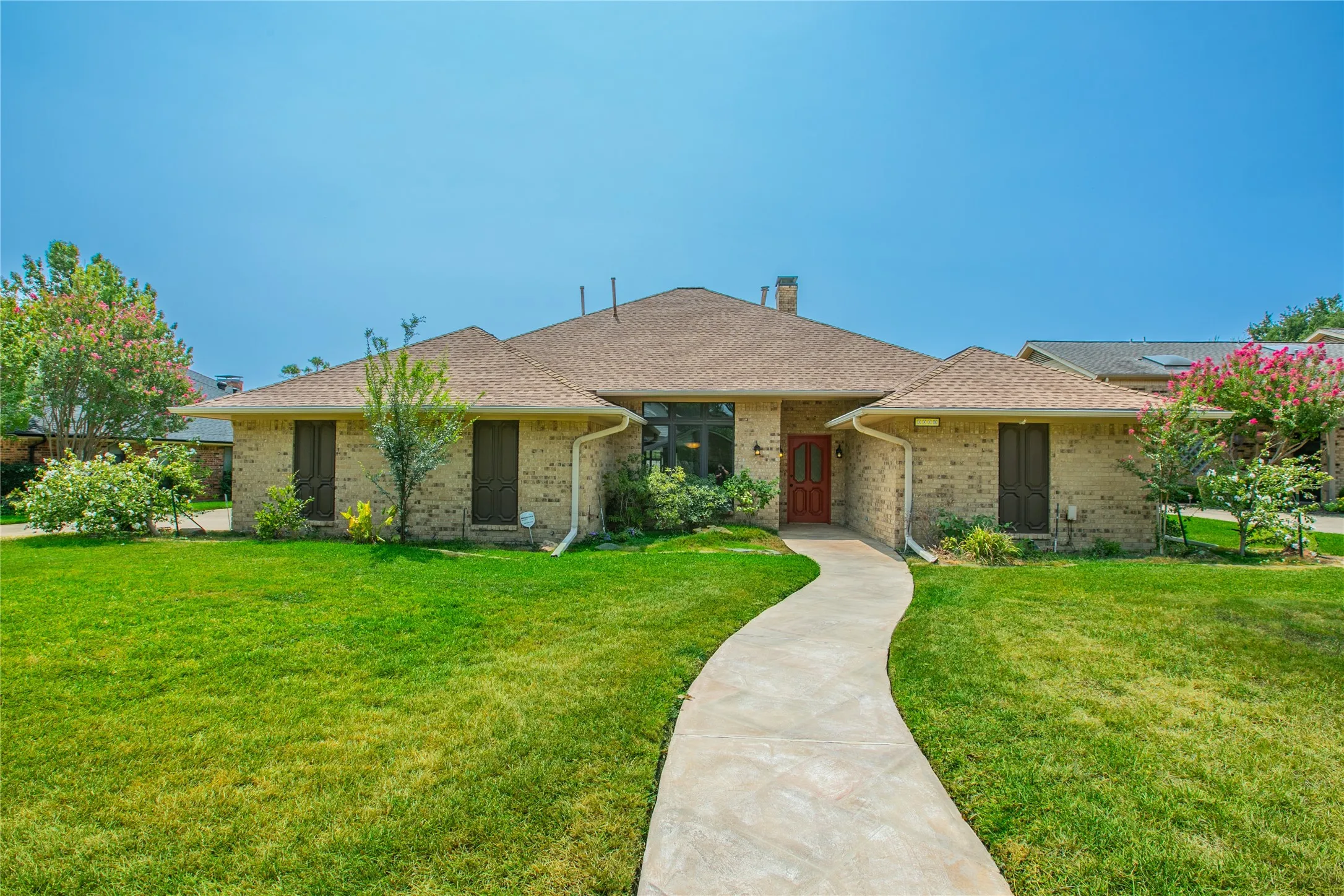 Single-story brick exterior with a pitched shingle roof