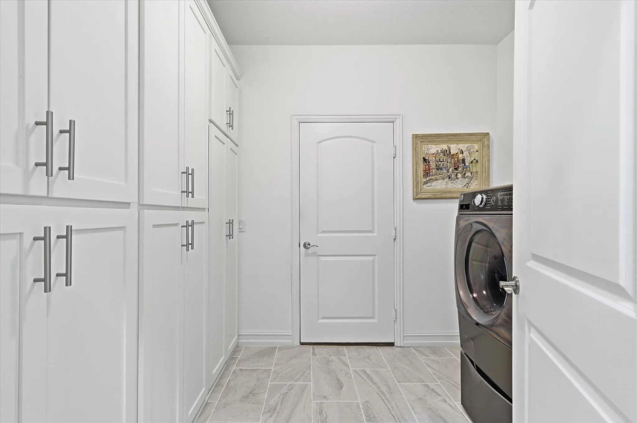 Look at all this built in storage in the large laundry room!