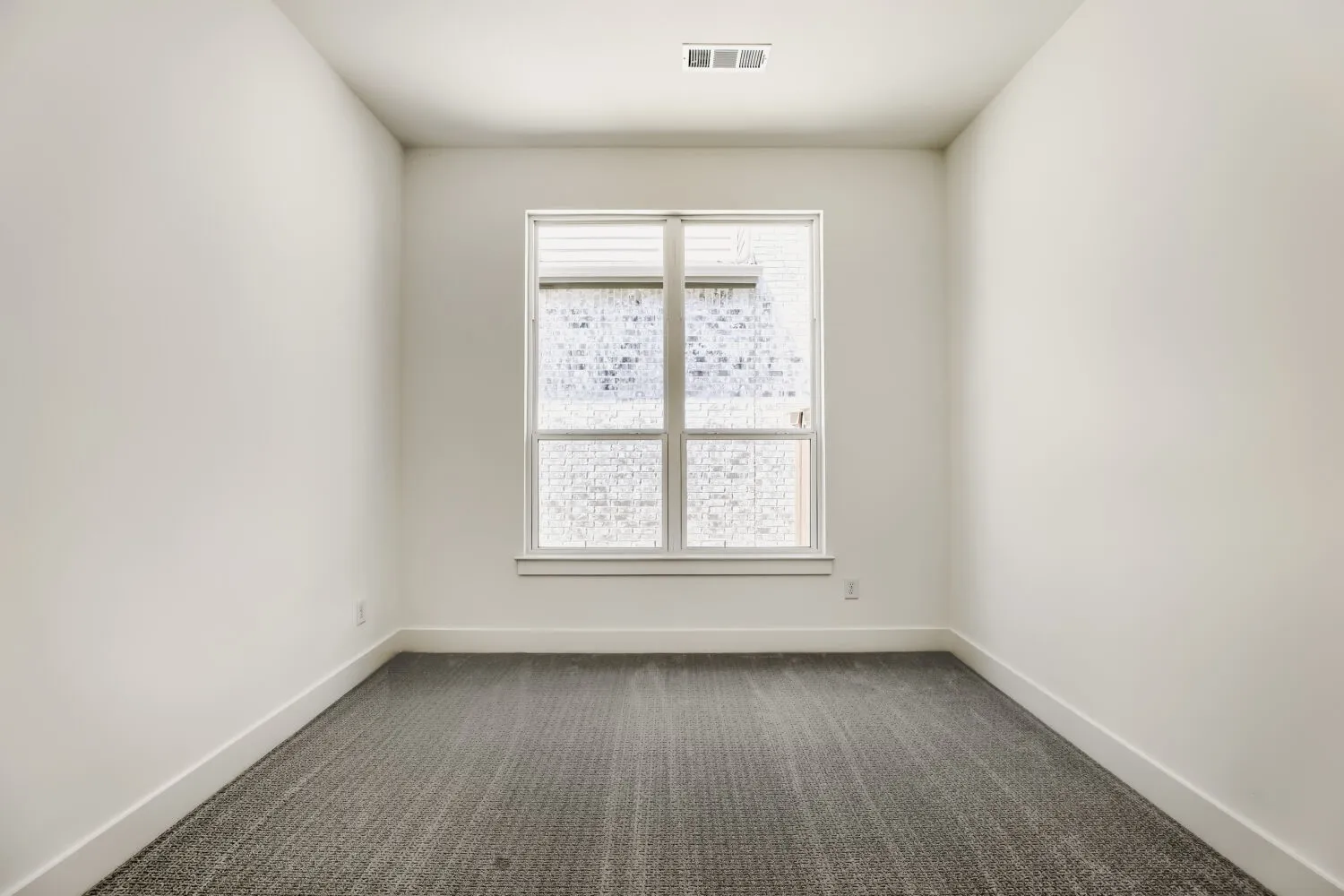 Neutral wall finishes and gray patterned carpeting