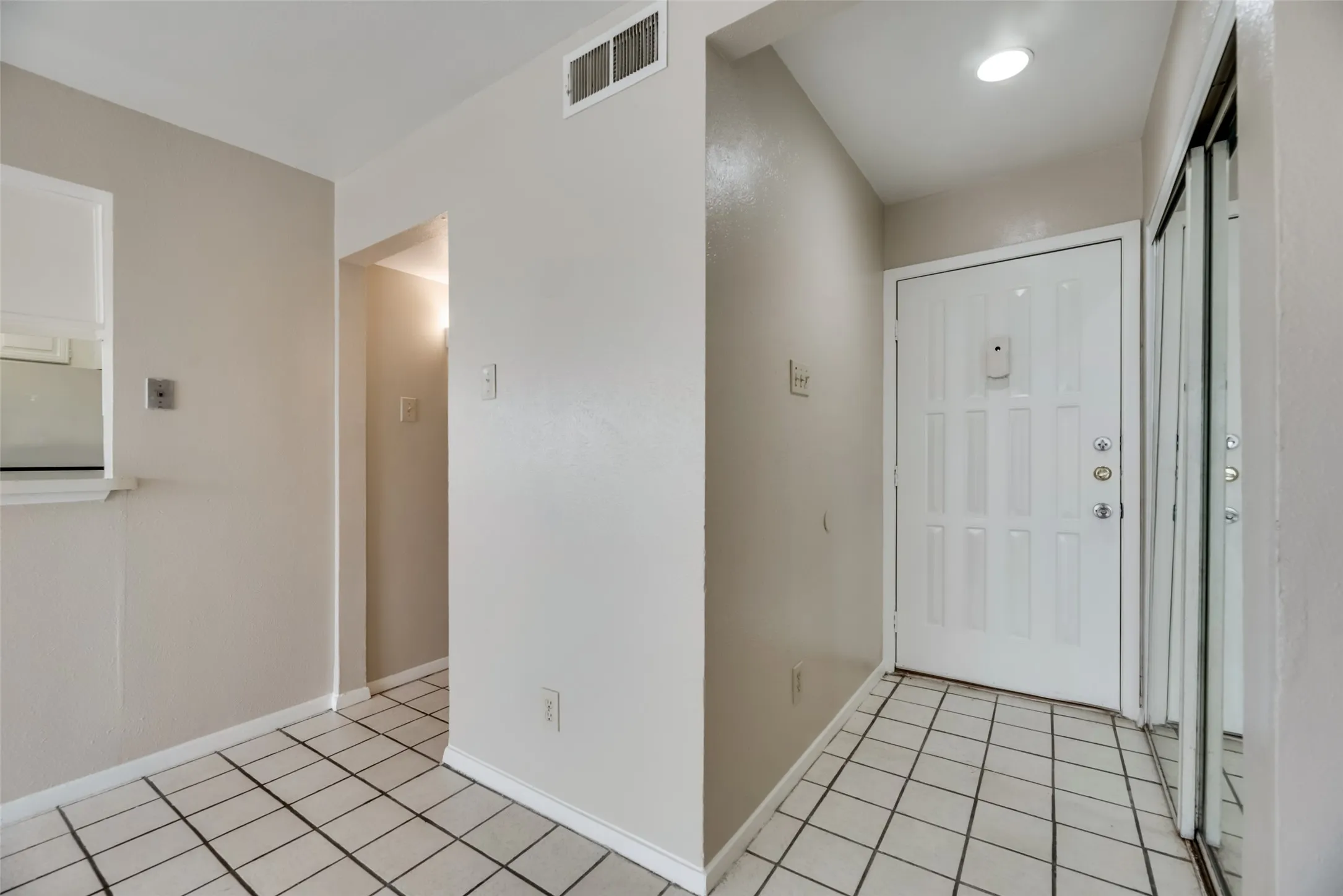Foyer entrance featuring light tile flooring