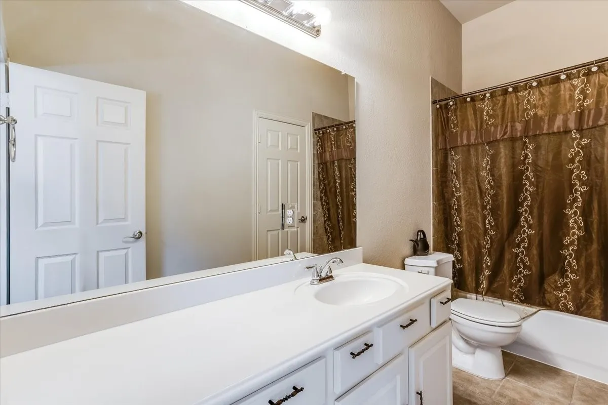 White vanity with an integrated sink and chrome faucet