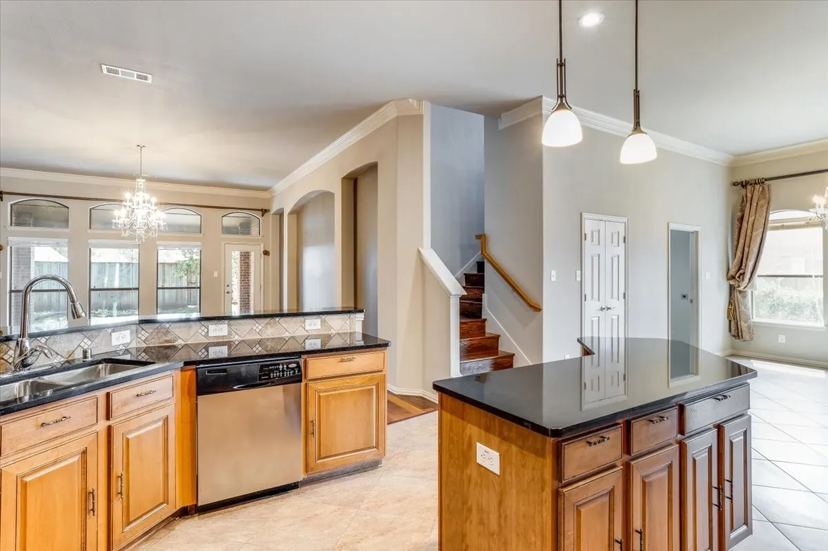 Kitchen featuring wood cabinetry, dark countertops, and a tiled backsplash