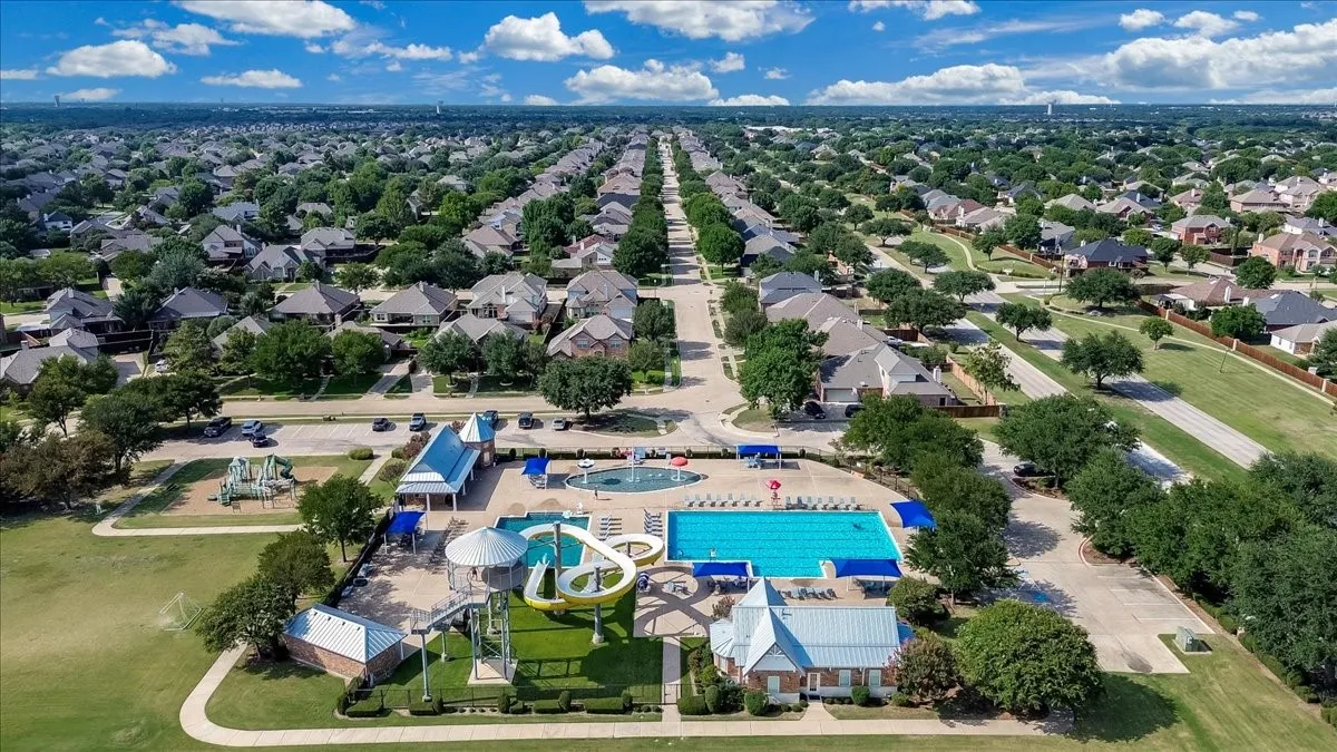 Community amenities featuring a large swimming pool, two water slides, and a separate wading pool