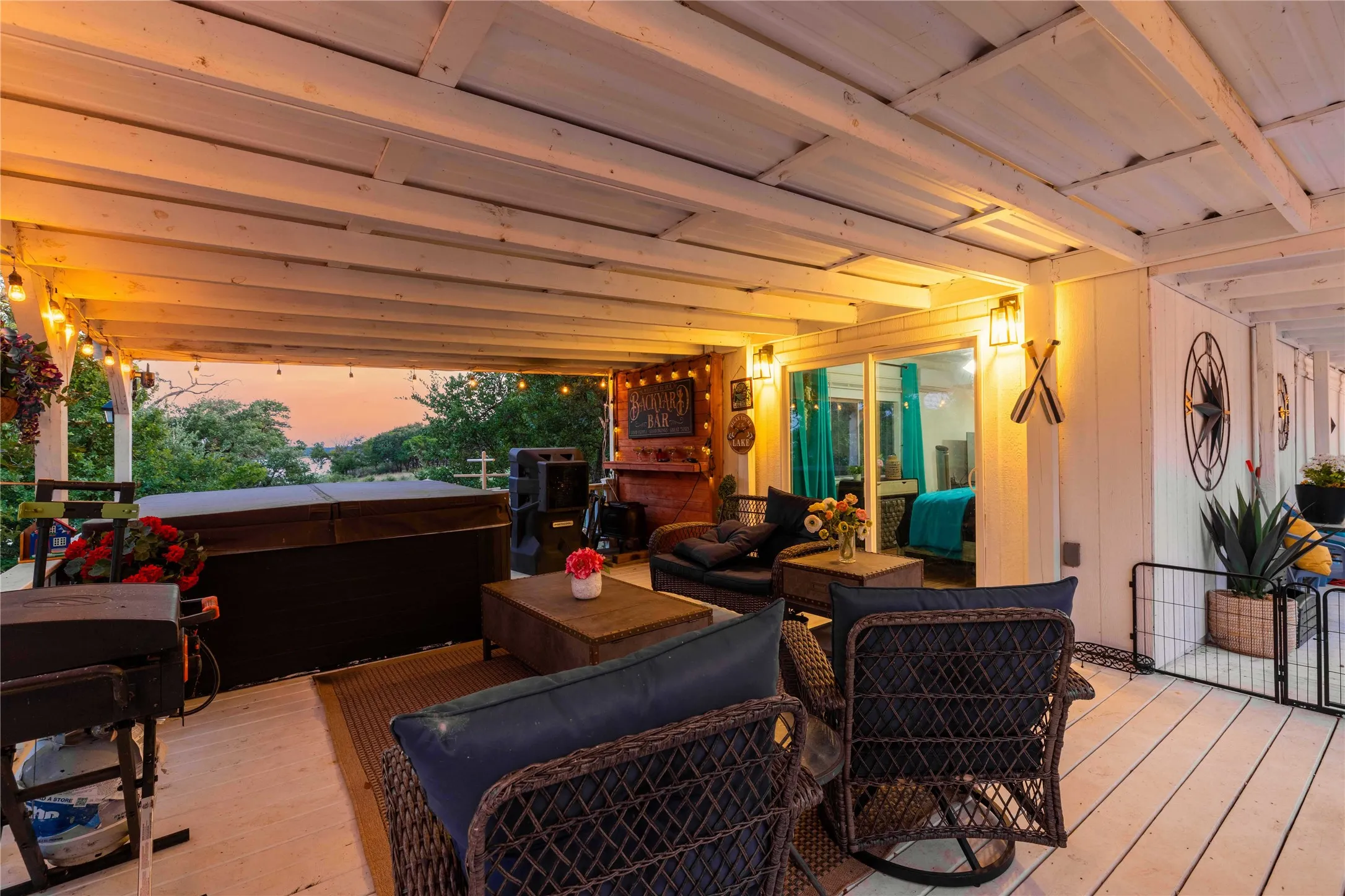 The covered lakeside deck is made for relaxing, entertaining, and soaking in the hot tub year-round.