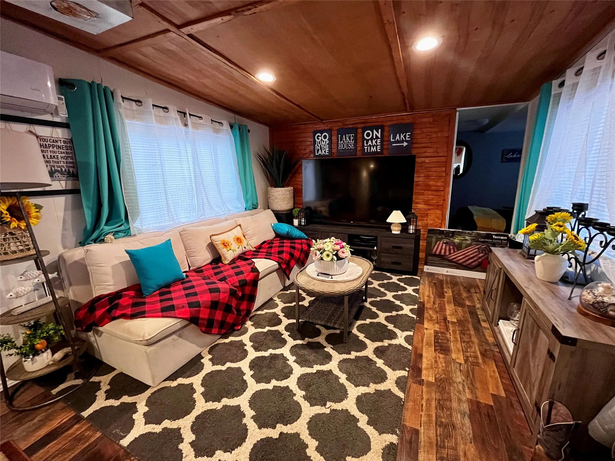 Comfortable living room featuring warm wood accents, abundant seating, and peaceful lakehouse charm.