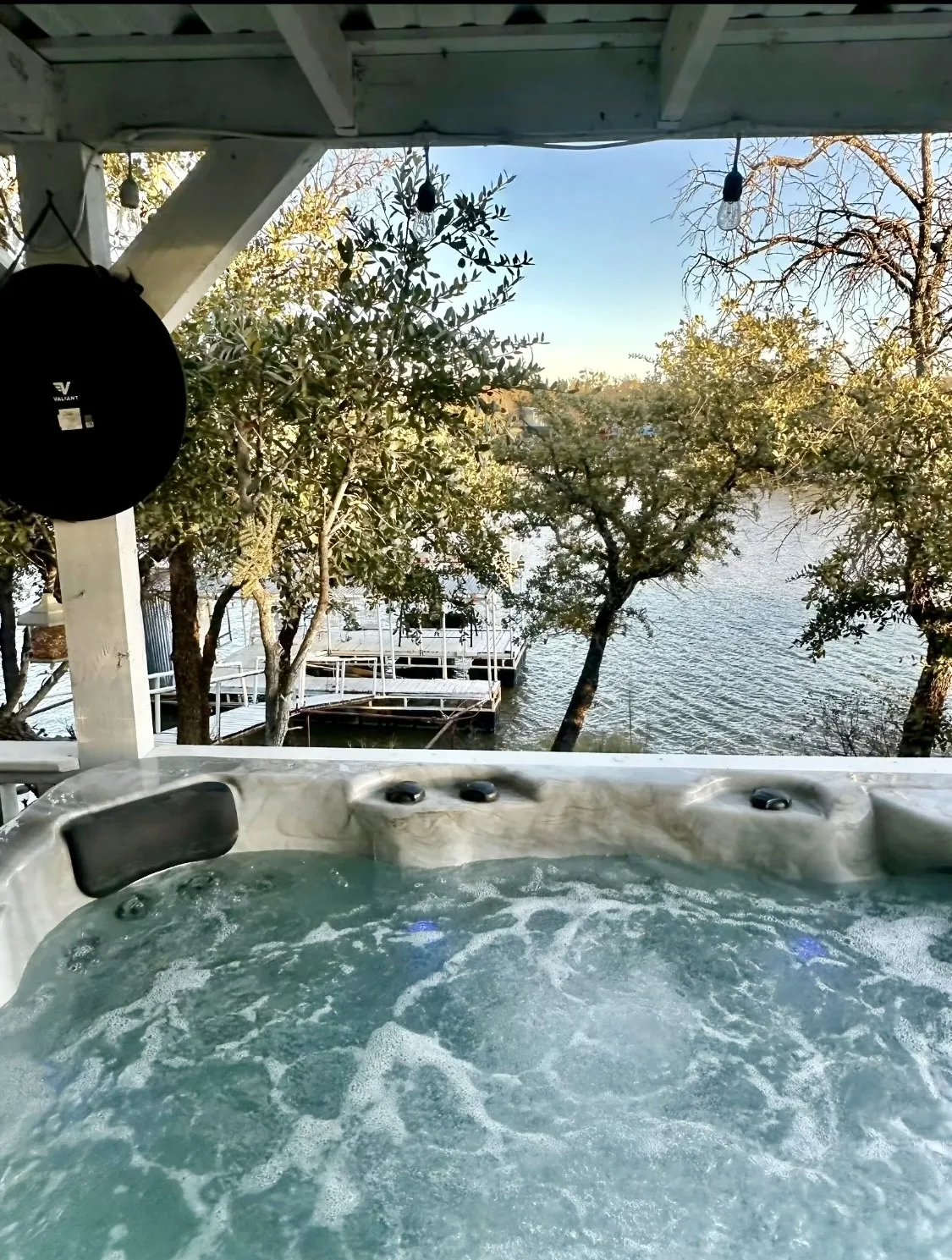 Hot tub included! Relax under the covered patio while enjoying peaceful lake views year-round.