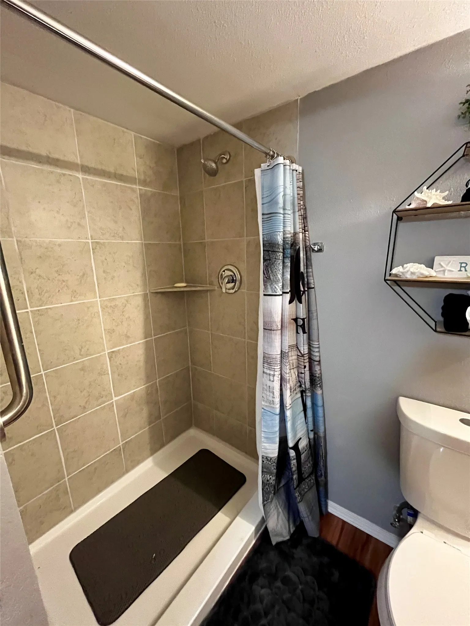 Updated ensuite bathroom with a beautifully tiled walk-in shower.