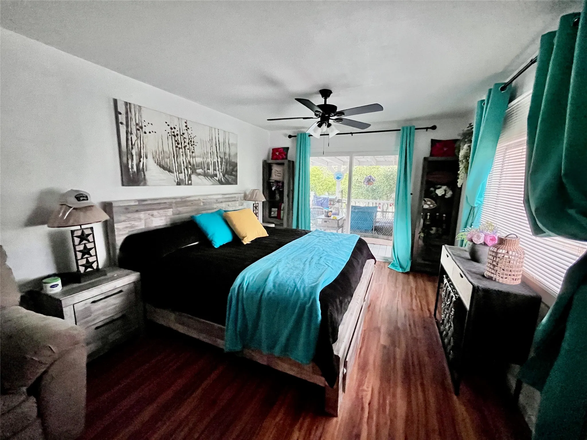 Private primary owner's suite with gorgeous views and sliding doors opening directly onto the covered lakeside porch.