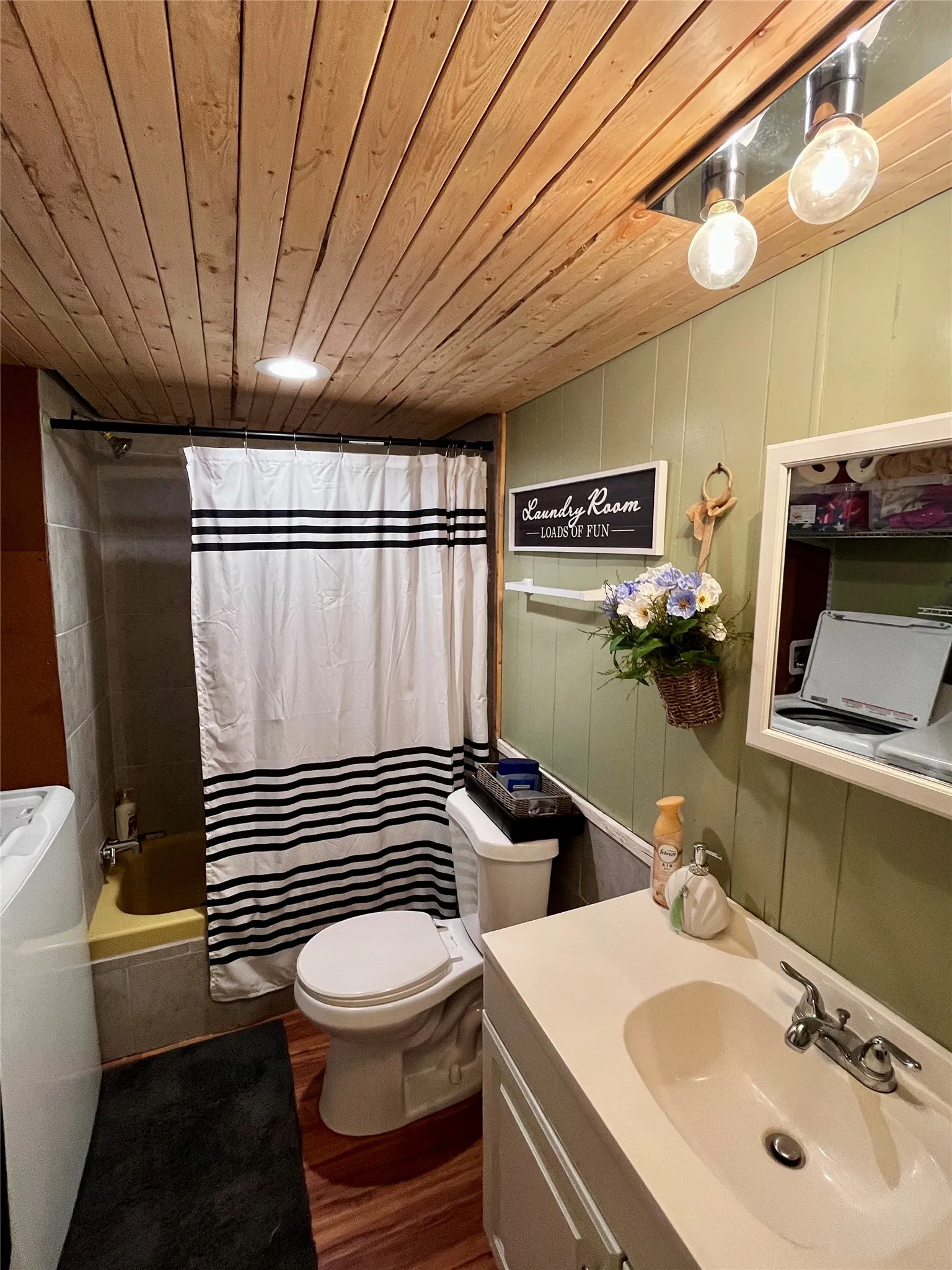 Full bathroom conveniently includes the laundry area for added functionality.