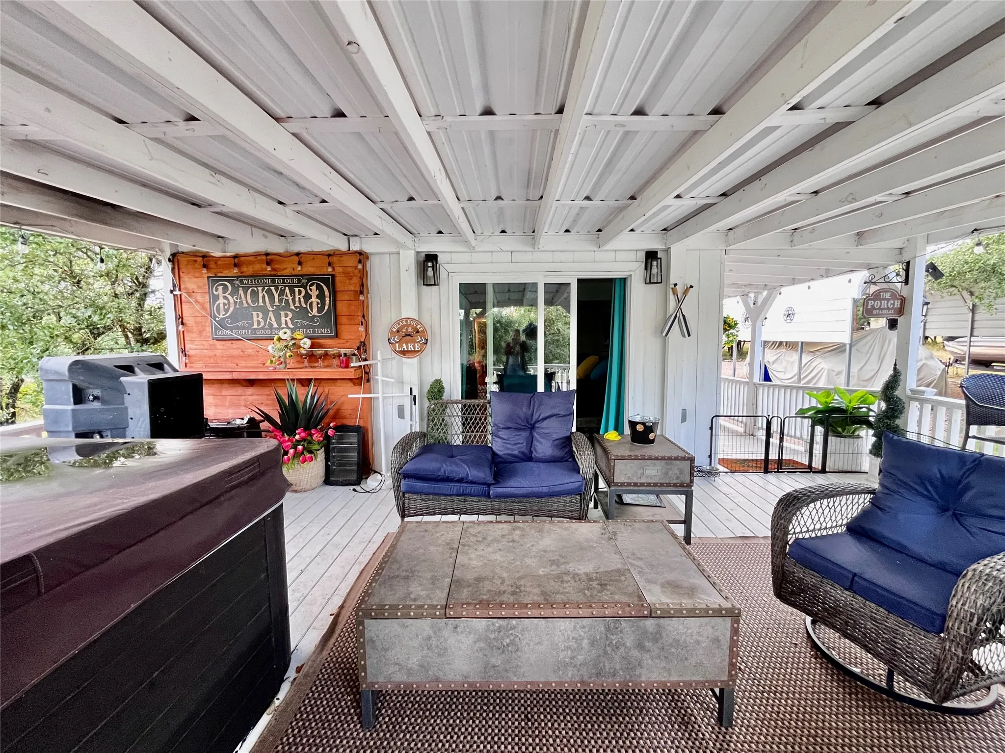 Expansive covered deck offers multiple gathering spaces for relaxing, dining, and entertaining year-round.