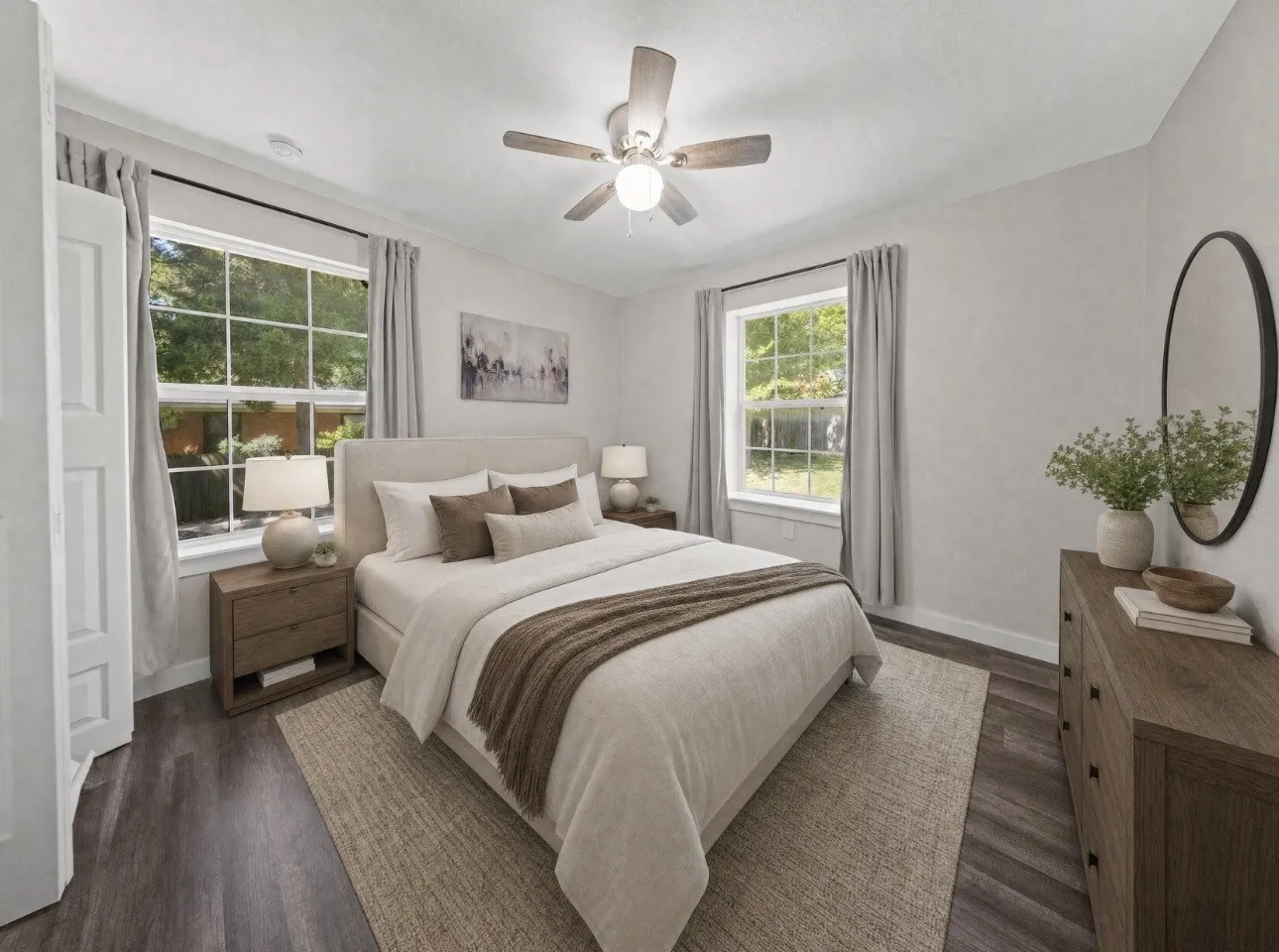 Room featuring wood-finish flooring, white trim, and a ceiling fan with integrated lighting