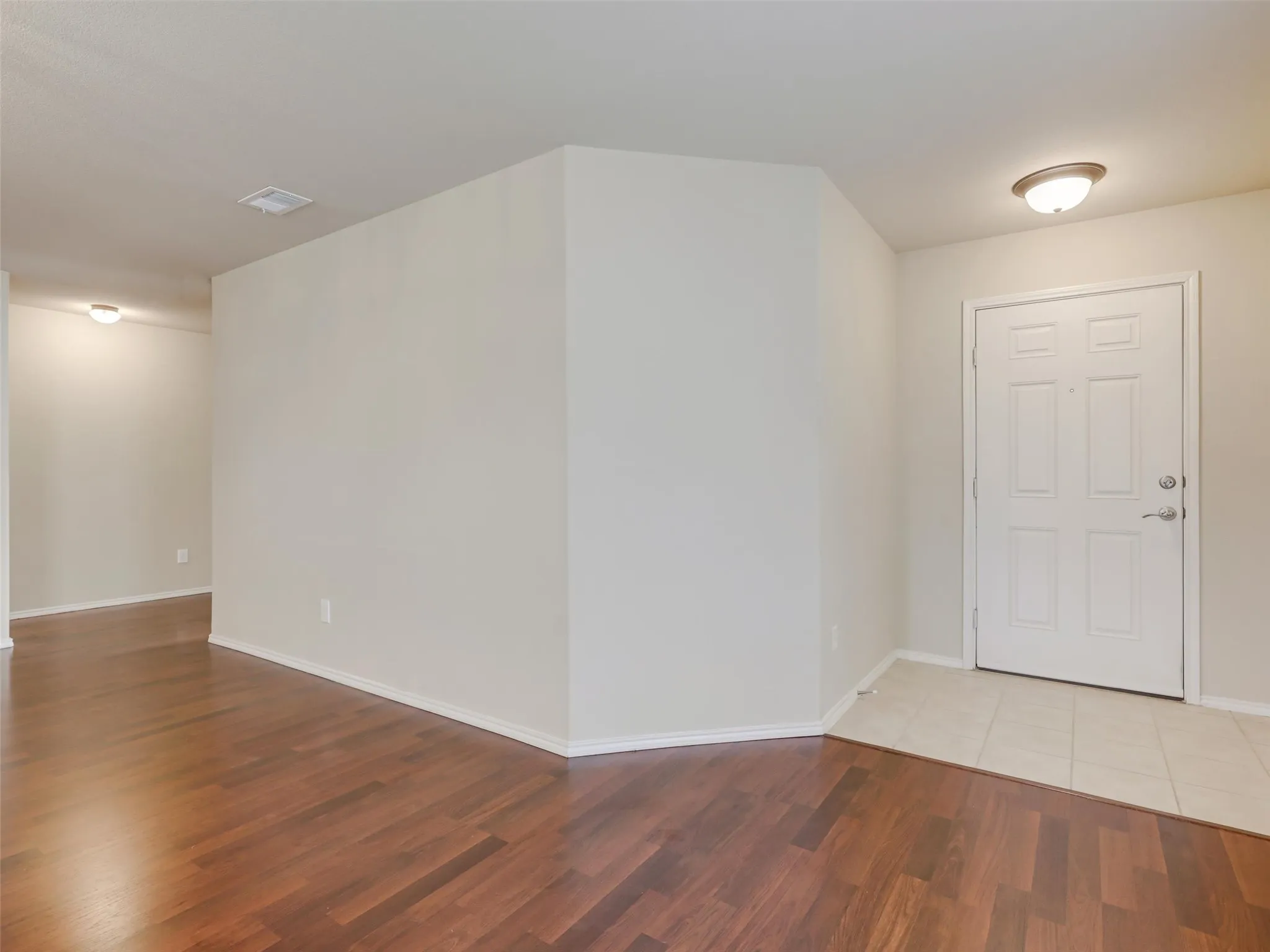Wood-finish flooring throughout, complemented by a tile entry