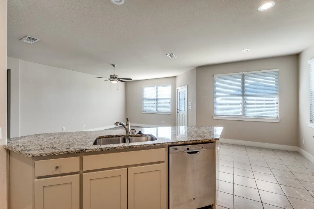 Kitchen island with dual basin sink and stainless steel dishwasher