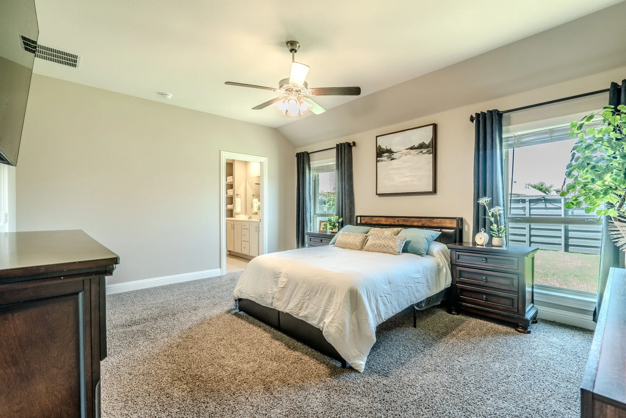 7329 Allium Court, Little Elm, TX 76227 - Primary Bedroom - Vaulted ceiling with a ceiling fan, carpet flooring, and multiple windows