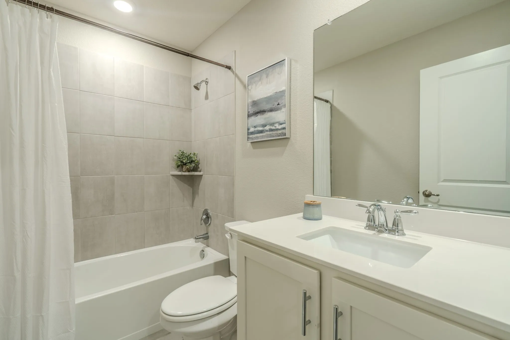 7329 Allium Court, Little Elm, TX 76227 - bathroom - Spa-inspired bathroom featuring a custom vanity with white quartz countertop, integrated rectangular sink, and polished chrome faucet