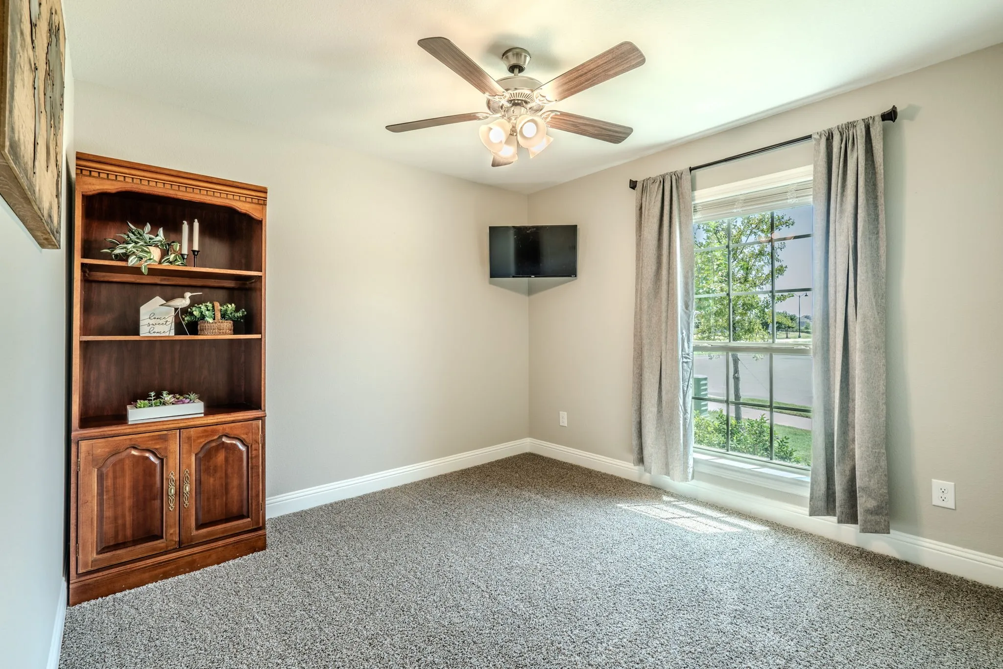 7329 Allium Court, Little Elm, TX 76227 - bedroom  - carpeted bedroom with ceiling fan and large window