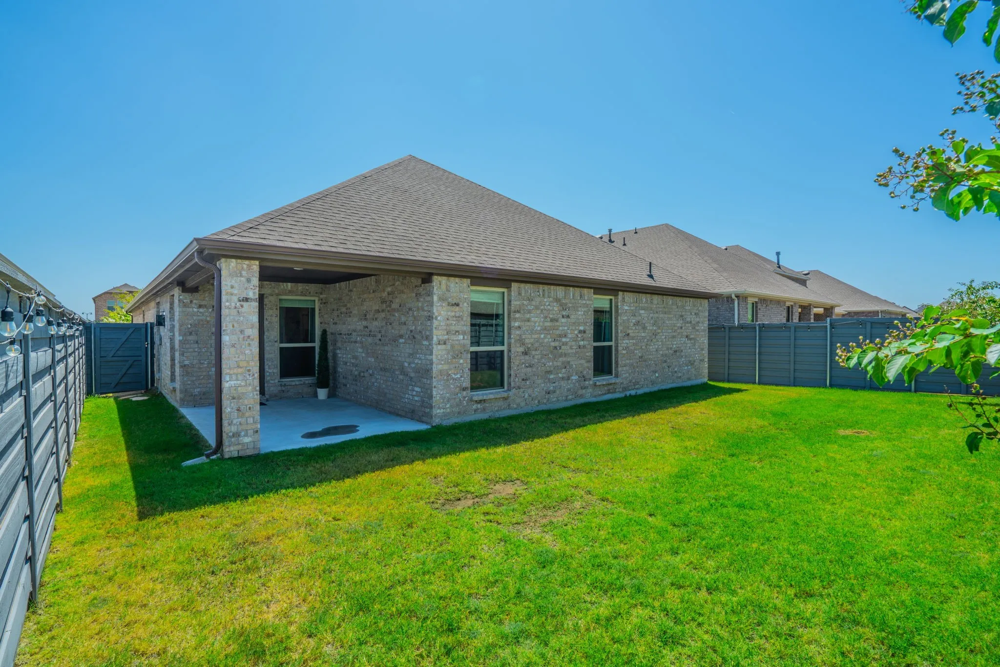 7329 Allium Court, Little Elm, TX 76227 -Brick exterior construction with a covered patio, shingled roof, and fenced yard