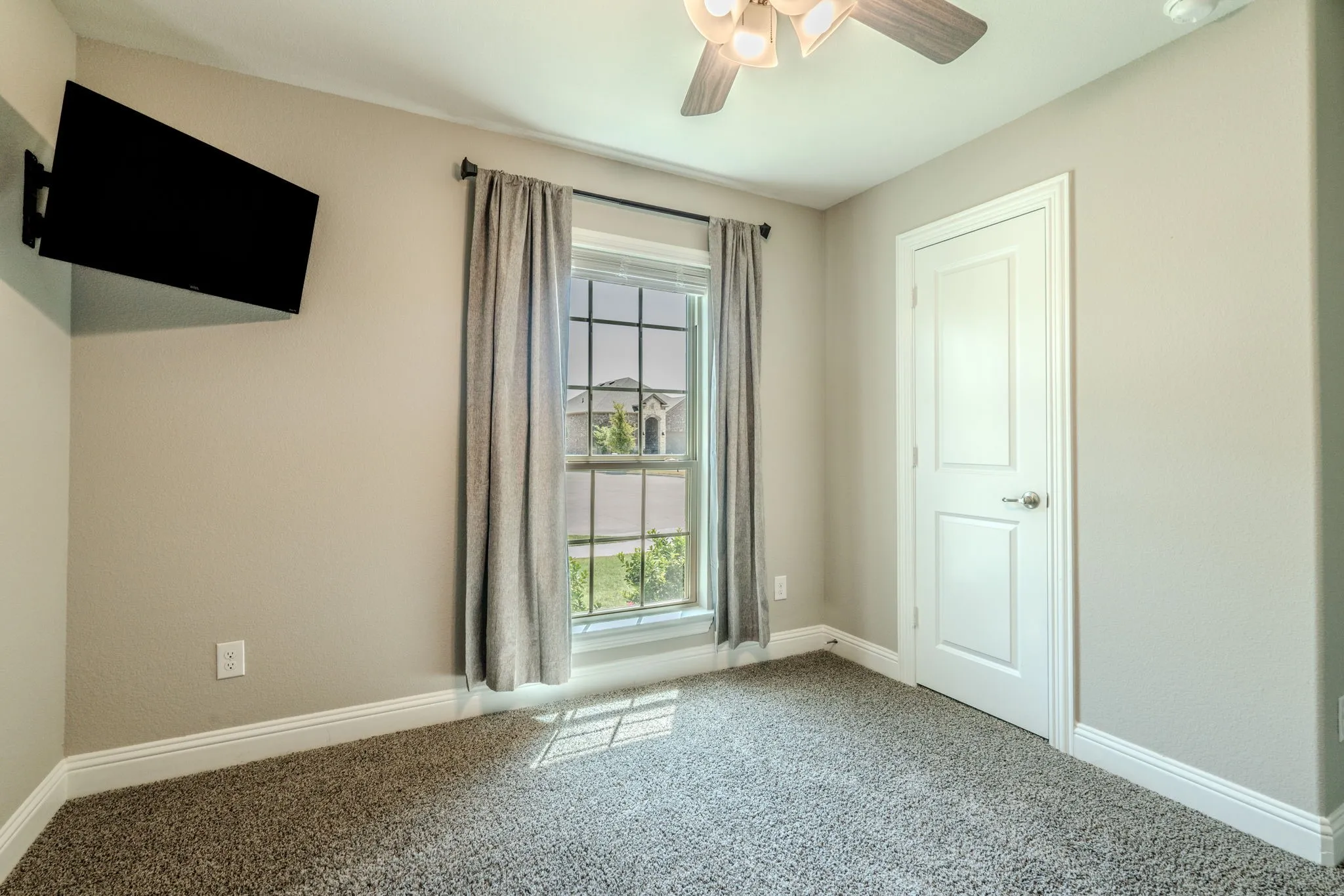 7329 Allium Court, Little Elm, TX 76227 - bedroom  - carpeted bedroom with ceiling fan and large window