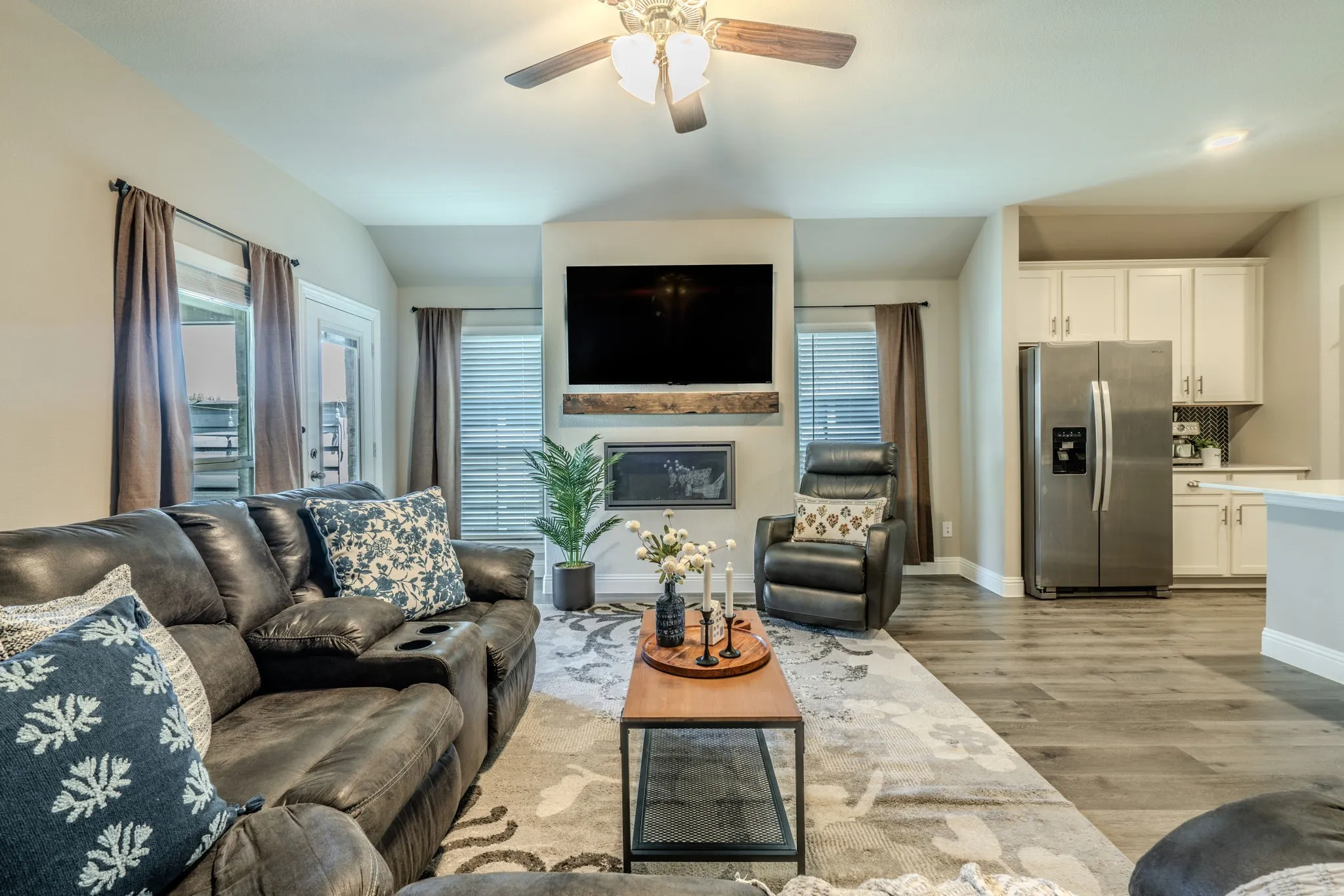 7329 Allium Court, Little Elm, TX 76227 - living room - Integrated living area with wood-finish flooring, a ceiling fan, and a built-in fireplace