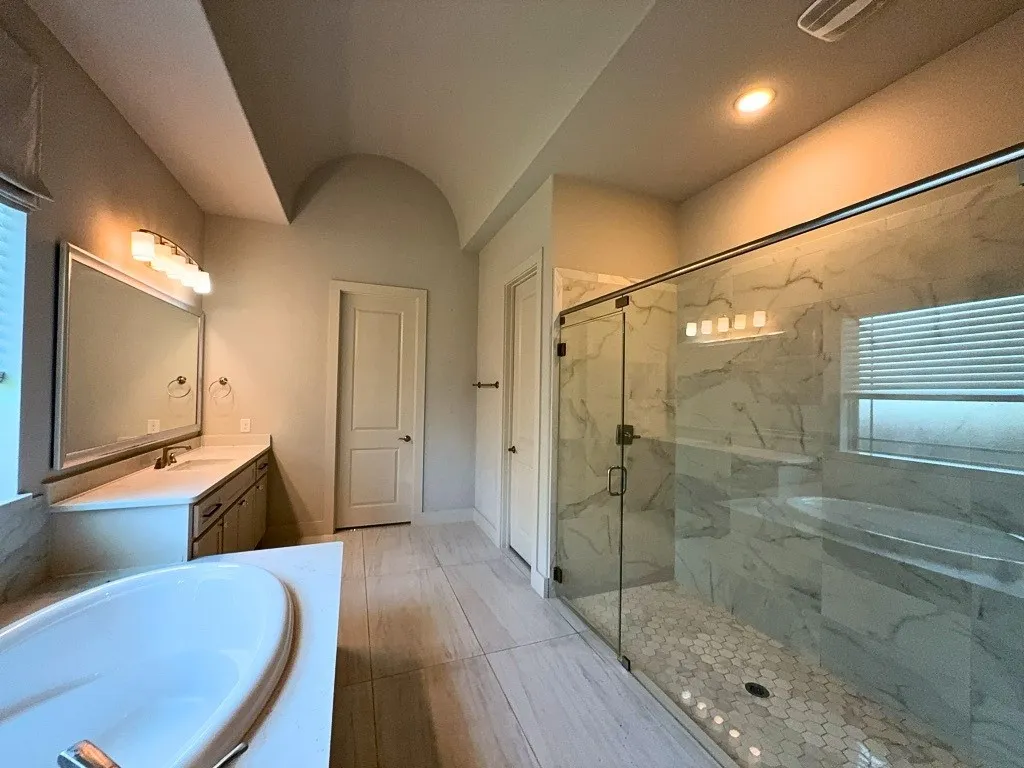 Primary bathroom with walk-in shower and soaking tub