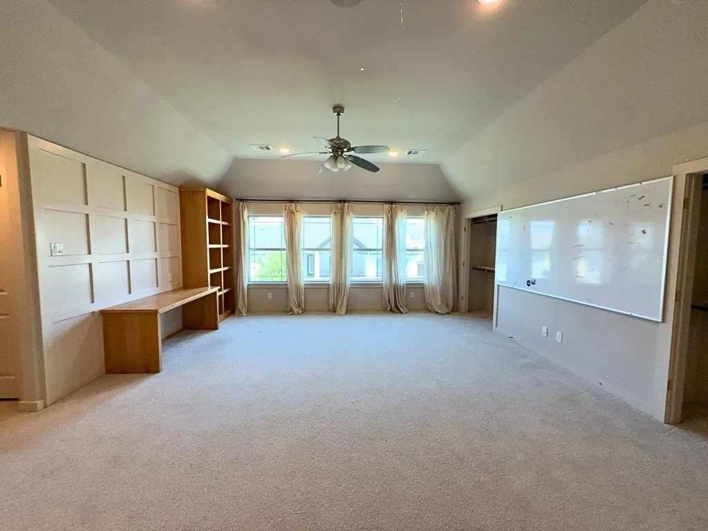 Game room with built-in desk and bookshelves